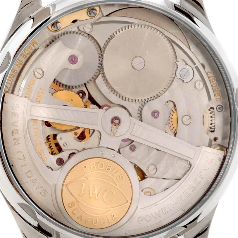 The image shows the back view of the IWC Portuguese IW500107 Men's Stainless Steel Silver Dial IW500107 Men's Stainless Steel Silver Dial watch, highlighting its internal mechanical movement and parts.