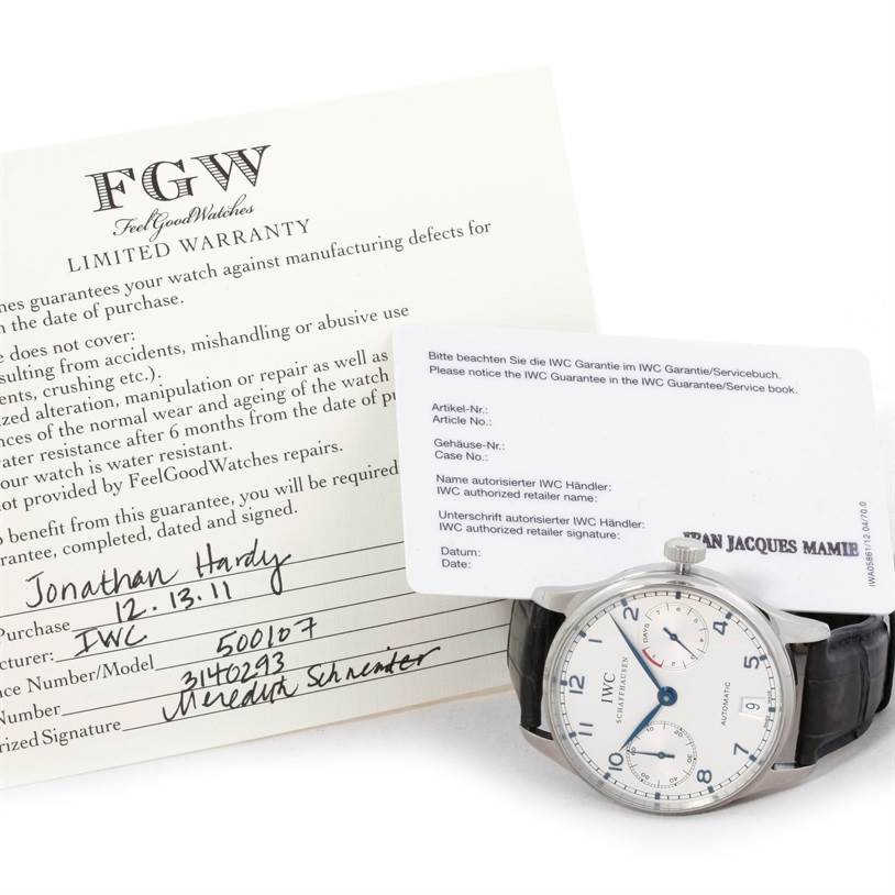 The image shows an IWC Portuguese IW500107 Men's Stainless Steel Silver Dial IW500107 Men's Stainless Steel Silver Dial model watch angled from the front with warranty cards in the background.