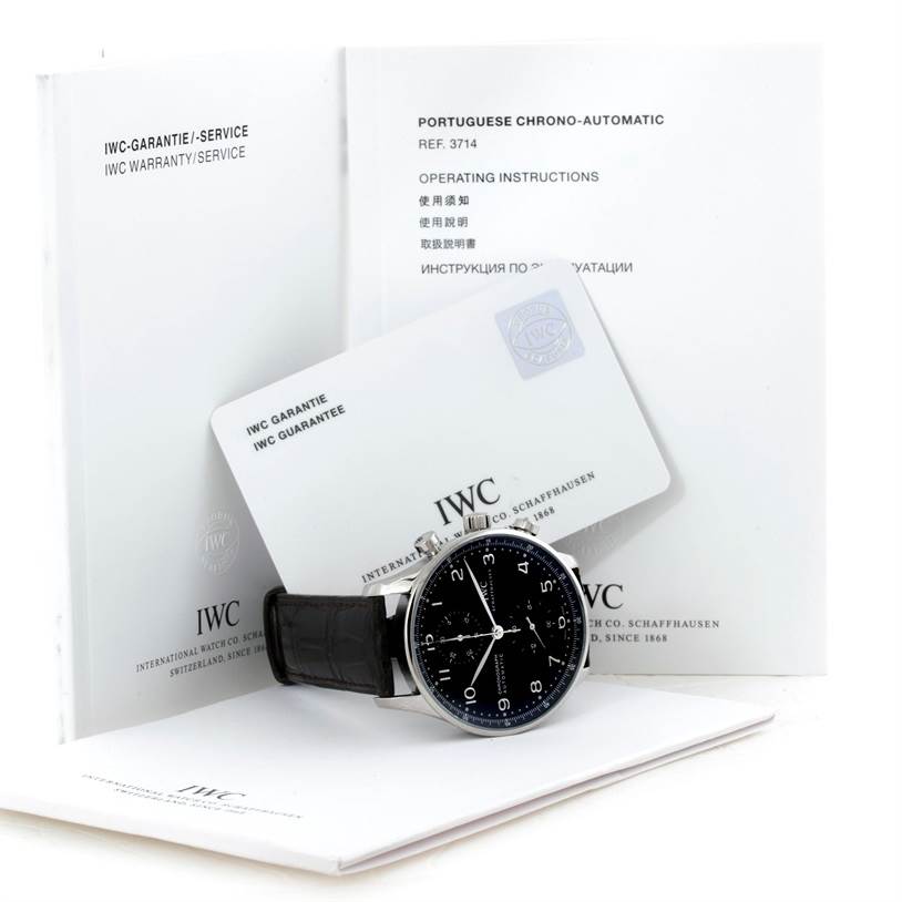 The image shows an IWC Portuguese IW371438 Men's Stainless Steel Black Dial IW371438 Men's Stainless Steel Black Dial Chrono-Automatic watch with its warranty and instruction booklets.