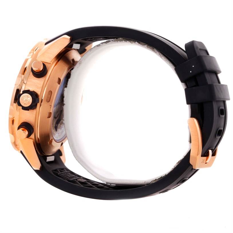 The IWC Aquatimer IW376903 Men's Rose Gold Black Dial IW376903 Men's Rose Gold Black Dial watch is shown from the side, highlighting the crown, pushers, case, and part of the rubber strap with a buckle.