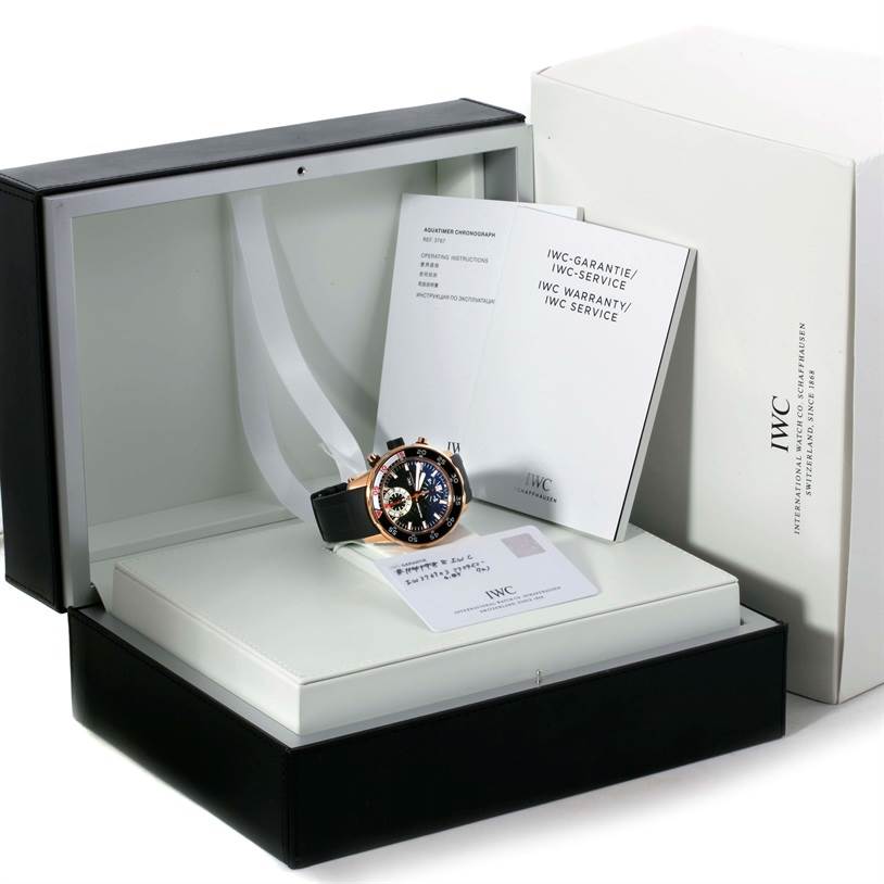 The image shows the IWC Aquatimer IW376903 Men's Rose Gold Black Dial IW376903 Men's Rose Gold Black Dial watch at a front angle, along with its box, warranty card, and instruction manuals.