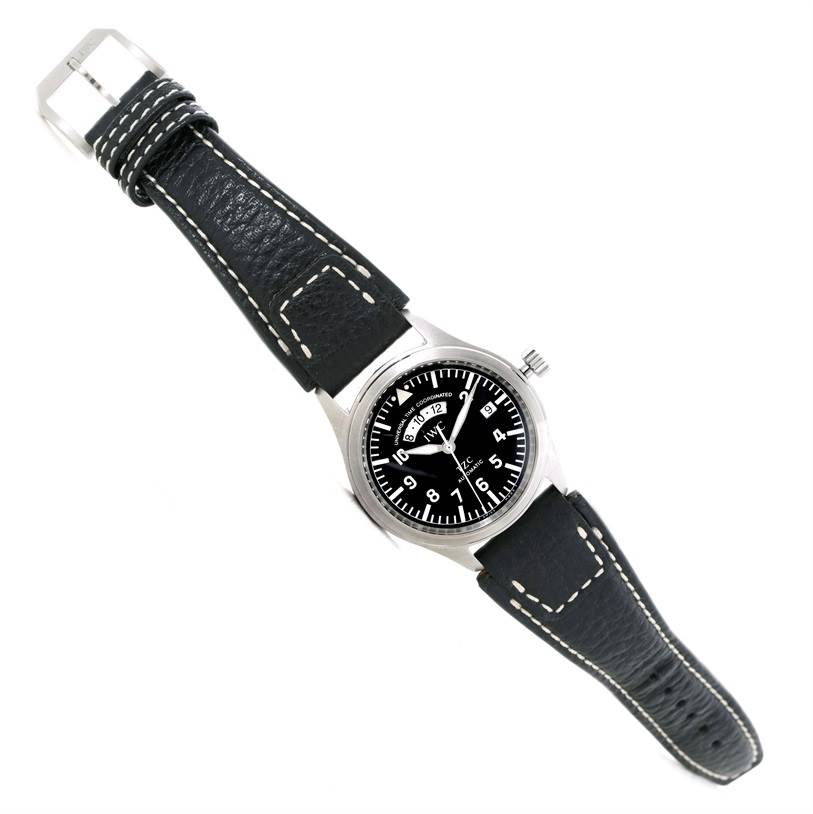 The image shows an IWC Pilot IW325101 Men's Stainless Steel Black Dial IW325101 Men's Stainless Steel Black Dial model watch at an angle highlighting the black dial, leather strap, and buckle.