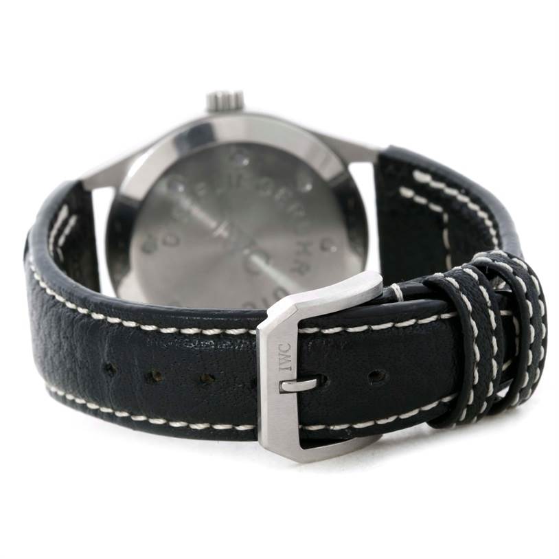The image shows the back angle of an IWC Pilot IW325101 Men's Stainless Steel Black Dial IW325101 Men's Stainless Steel Black Dial model watch, highlighting its buckle and leather strap.