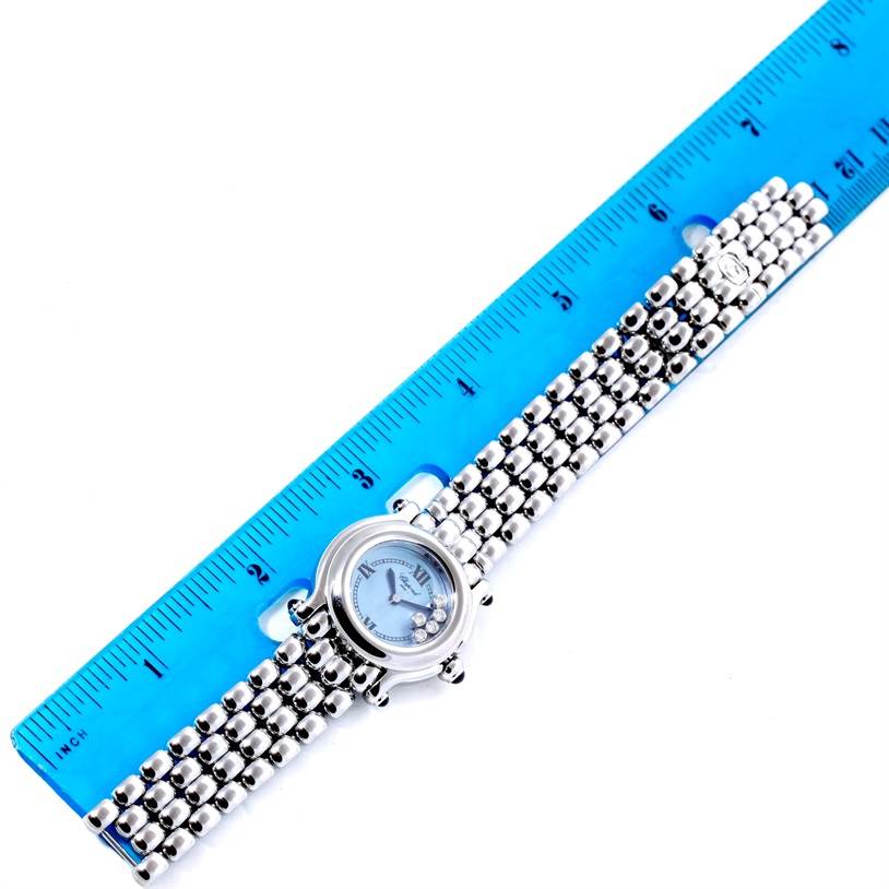 The Chopard 27/8250-23 Women's Stainless Steel Mother of Pearl Dial 27/8250-23 Women's Stainless Steel Mother of Pearl Dial Happy Sport Bleu Dial 5 Floating Diamonds Watch 27/8250-23 is shown flat with a ruler, displaying the dial and metallic band.