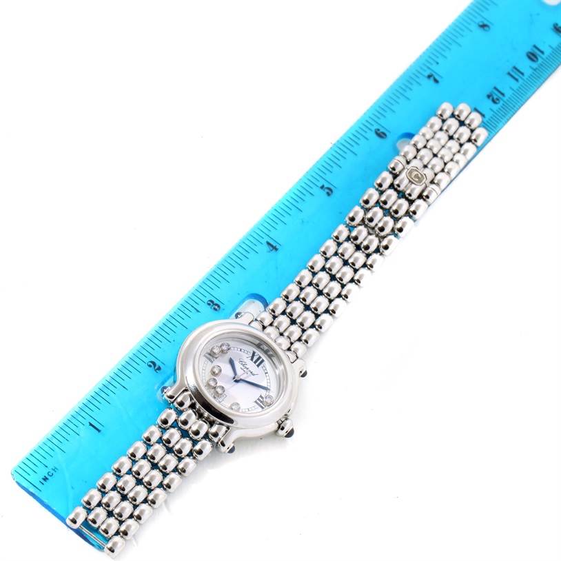 The Chopard 278236-3005 Women's Stainless Steel White Dial 278236-3005 Women's Stainless Steel White Dial Happy Sport White Dial Floating Diamond Watch 278236-3005 is shown from a top-down angle, displaying the face, bezel, and band next to a blue ruler.