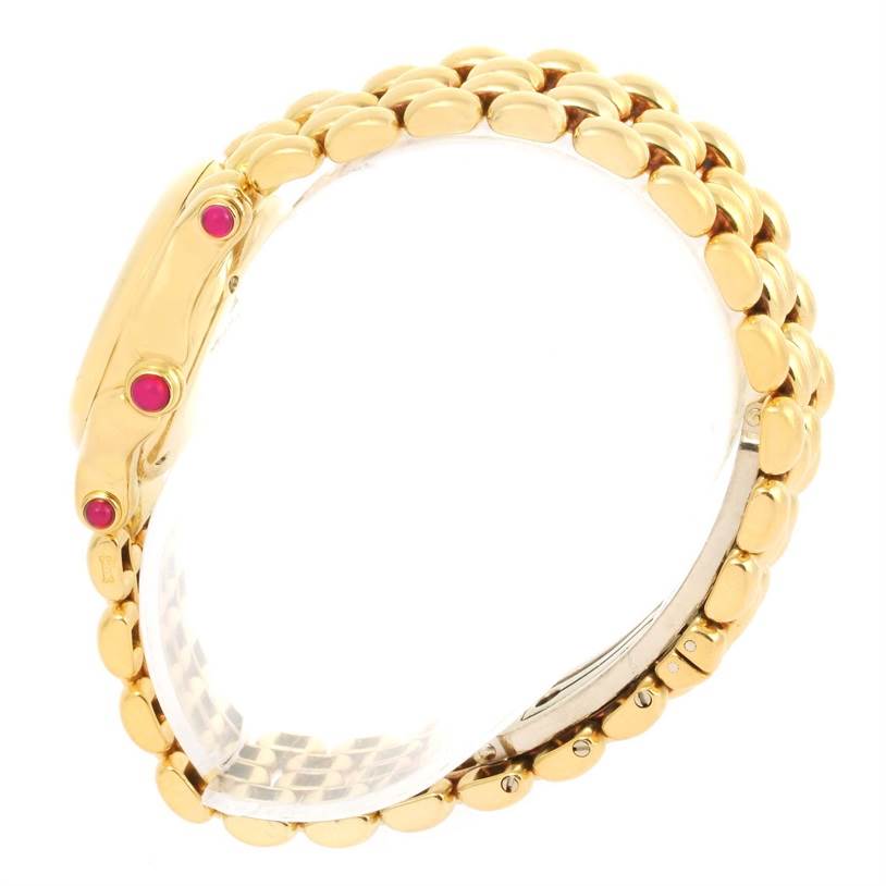 The Chopard 27/6150-21 Women's Yellow Gold White Dial 27/6150-21 Women's Yellow Gold White Dial Happy Sport Yellow Gold Floating Diamonds Watch 27/6150-21 is shown from a side angle, highlighting the gold bracelet and red accents. 
