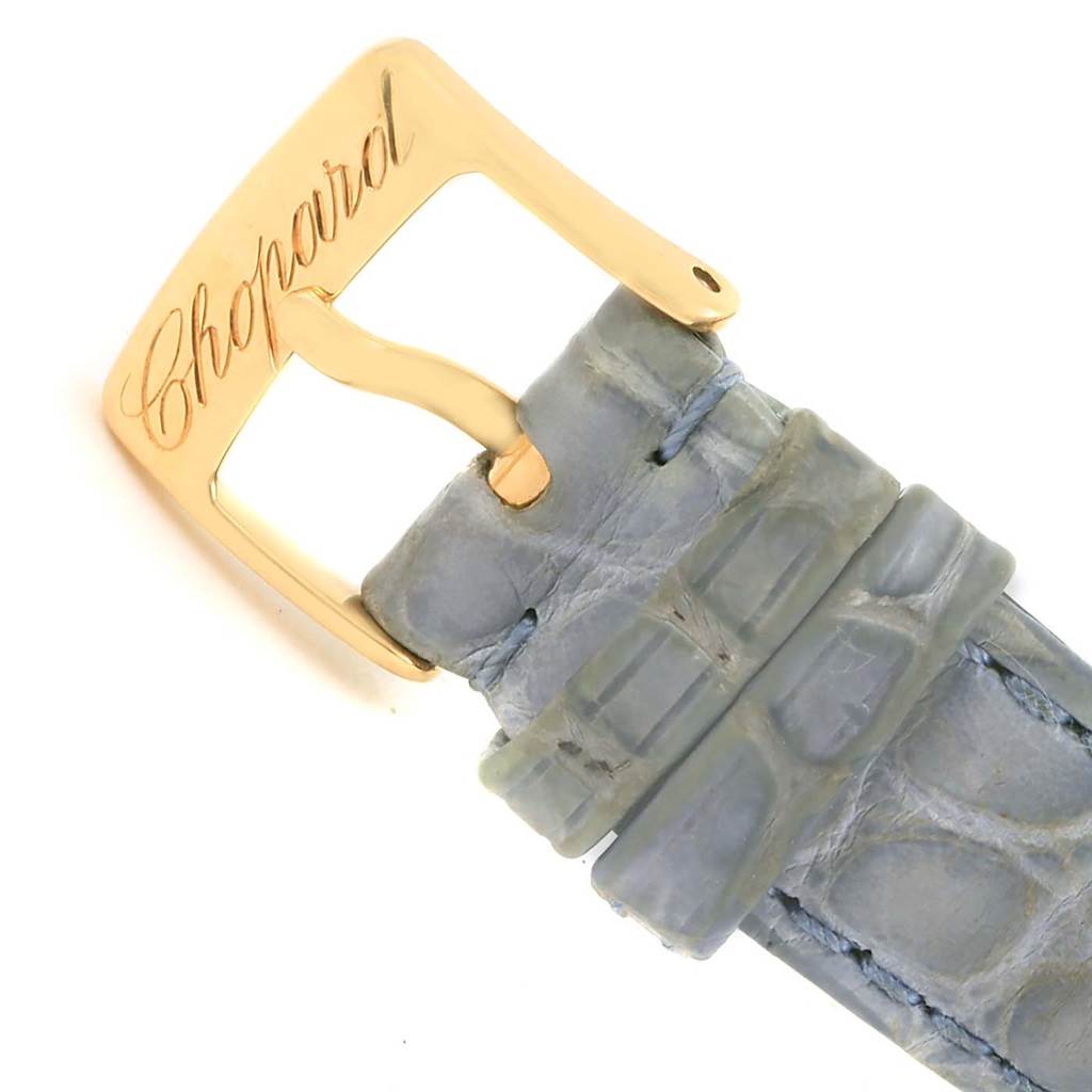 This image shows the gold buckle and part of the blue strap of the Chopard 27/7012-23 Women's Yellow Gold White Dial 27/7012-23 Women's Yellow Gold White Dial Happy Diamond Yellow Gold Floating Diamonds Watch model 27/7012-23.