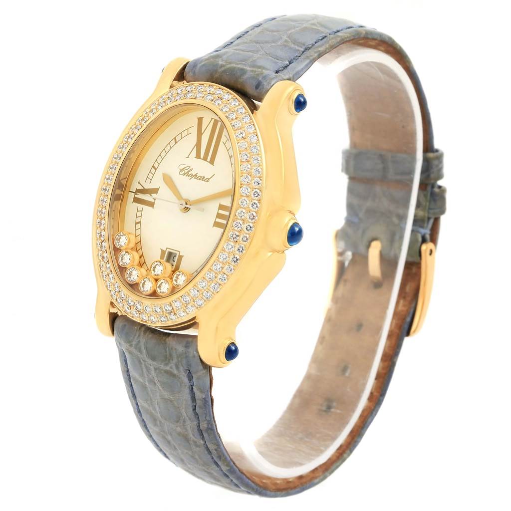 The image shows a side angle view of the Chopard 27/7012-23 Women's Yellow Gold White Dial 27/7012-23 Women's Yellow Gold White Dial Happy Diamond Yellow Gold Floating Diamonds Watch 27/7012-23, highlighting the face, strap, and bezel.