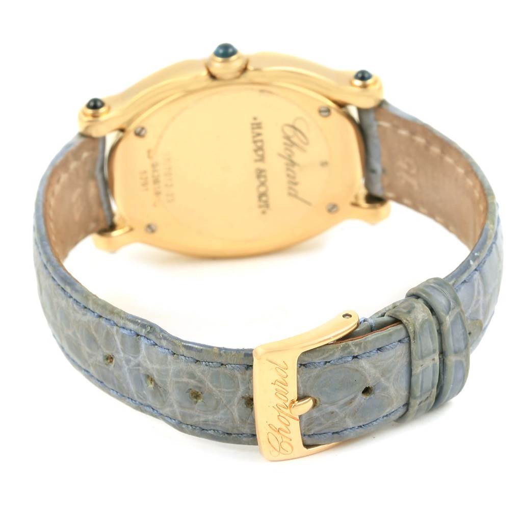 The image shows the back view of the Chopard 27/7012-23 Women's Yellow Gold White Dial 27/7012-23 Women's Yellow Gold White Dial Happy Diamond Yellow Gold Floating Diamonds Watch 27/7012-23, focusing on the gold caseback and leather strap.