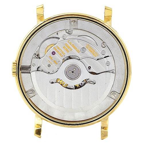 The image shows the back of the Chopard 16-1223 Yellow Gold White Dial 16-1223 Yellow Gold White Dial Les Classique Luc Homme 18k Yellow Gold 16/1223 watch, highlighting its exposed mechanical movement.
