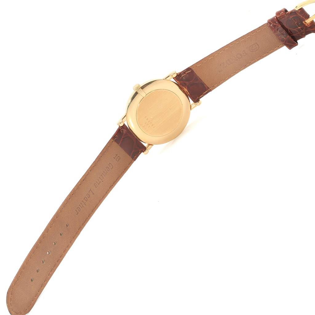 This image shows the back view of the Chopard Classique 16/3154 Men's Yellow Gold White Dial 16/3154 Men's Yellow Gold White Dial watch, displaying the leather strap and the gold watch case back.