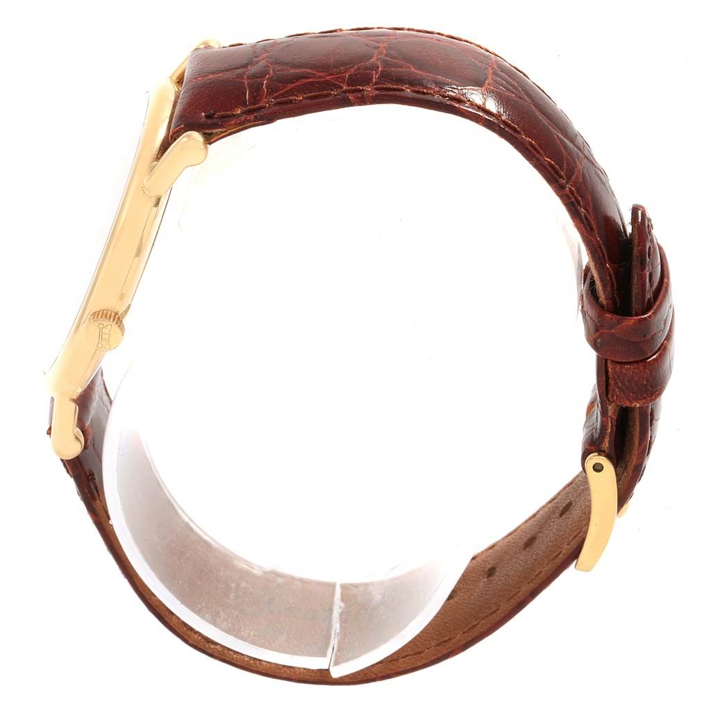 The angle shows a side view of the Chopard Classique 16/3154 Men's Yellow Gold White Dial 16/3154 Men's Yellow Gold White Dial watch, highlighting the case, crown, and brown leather strap with buckle.