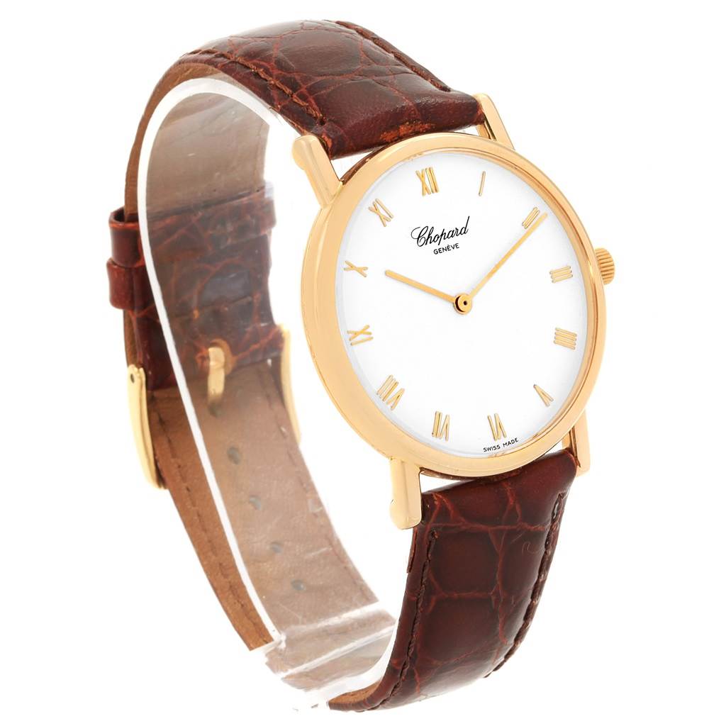 The Classique model by Chopard is shown at an angled view, displaying its round face, leather strap, and gold-tone case.