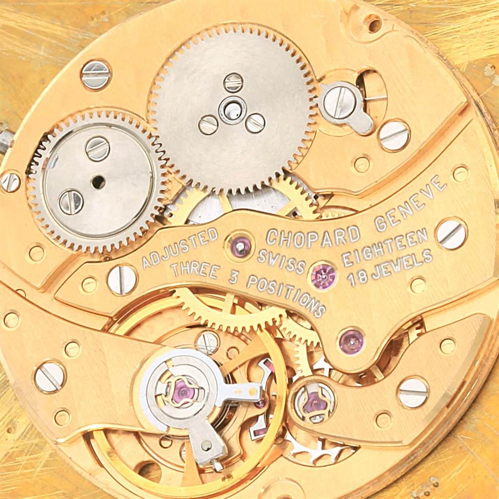 The image shows the internal mechanical movement of the Chopard Classique 16/3154 Men's Yellow Gold White Dial 16/3154 Men's Yellow Gold White Dial watch, highlighting gears, jewels, and engraved text.