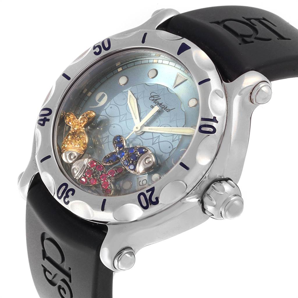 The Chopard 288347 Women's Stainless Steel Blue Dial 288347 Women's Stainless Steel Blue Dial Happy Beach Floating Rubi Sapphire Fish Ladies Watch 288347 is shown at an oblique angle, highlighting the bezel, dial, and strap.