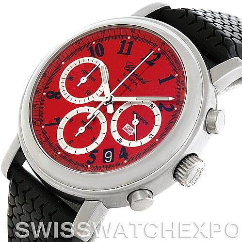 This image shows a Chopard Mille Miglia 16-8331 Men's Stainless Steel Red Dial 16-8331 Men's Stainless Steel Red Dial watch at an angled view, highlighting its red dial, chronograph subdials, and black textured strap.