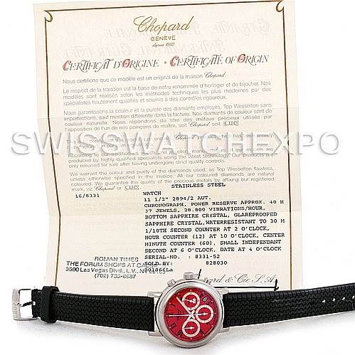 The image shows a Chopard Mille Miglia 16-8331 Men's Stainless Steel Red Dial 16-8331 Men's Stainless Steel Red Dial watch with a red dial, black strap, and accompanying certificate of origin from an overhead angle.
