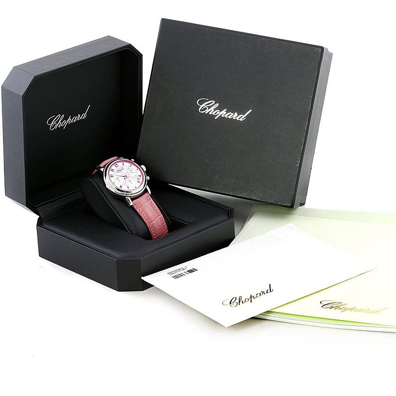 The image shows a Chopard Mille Miglia 8331 Men's Stainless Steel Pink Dial 8331 Men's Stainless Steel Pink Dial watch at an angle in its open presentation box with accompanying documents.