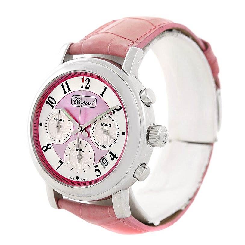 The Chopard Mille Miglia 8331 Men's Stainless Steel Pink Dial 8331 Men's Stainless Steel Pink Dial watch is shown at a slight angle, featuring its dial, crown, pushers, and pink strap.