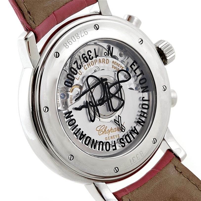 The image shows the back of the Chopard Mille Miglia 8331 Men's Stainless Steel Pink Dial 8331 Men's Stainless Steel Pink Dial watch, featuring an Elton John AIDS Foundation engraving and a transparent case back.