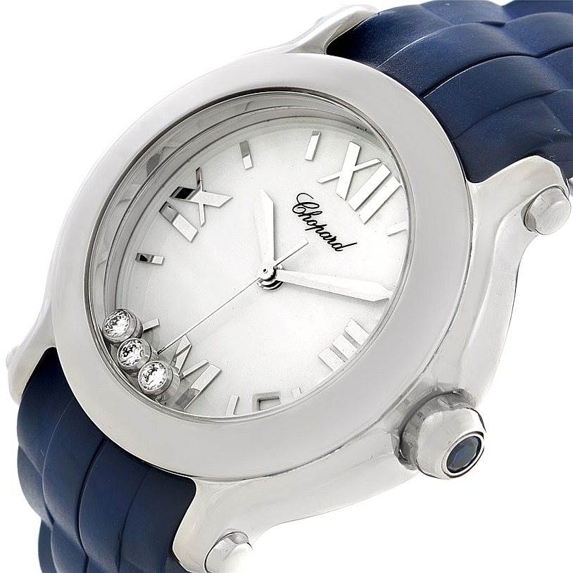 The image shows a close-up angle of the Chopard 278475 Women
s Stainless Steel Silver Dial 278475 Women
s Stainless Steel Silver Dial Happy Sport Floating Diamond Rubber Strap Watch 278475, highlighting its face and crown.