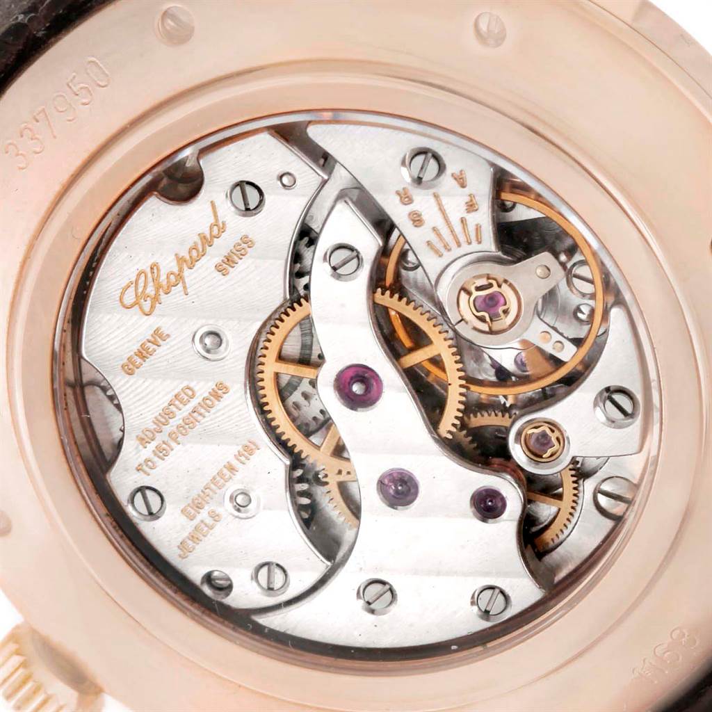 This image shows the intricate internal mechanism of the Chopard Classique 16/1168 Men's Rose Gold Black Dial 16/1168 Men's Rose Gold Black Dial watch from a close-up angle, highlighting the gears and engravings.