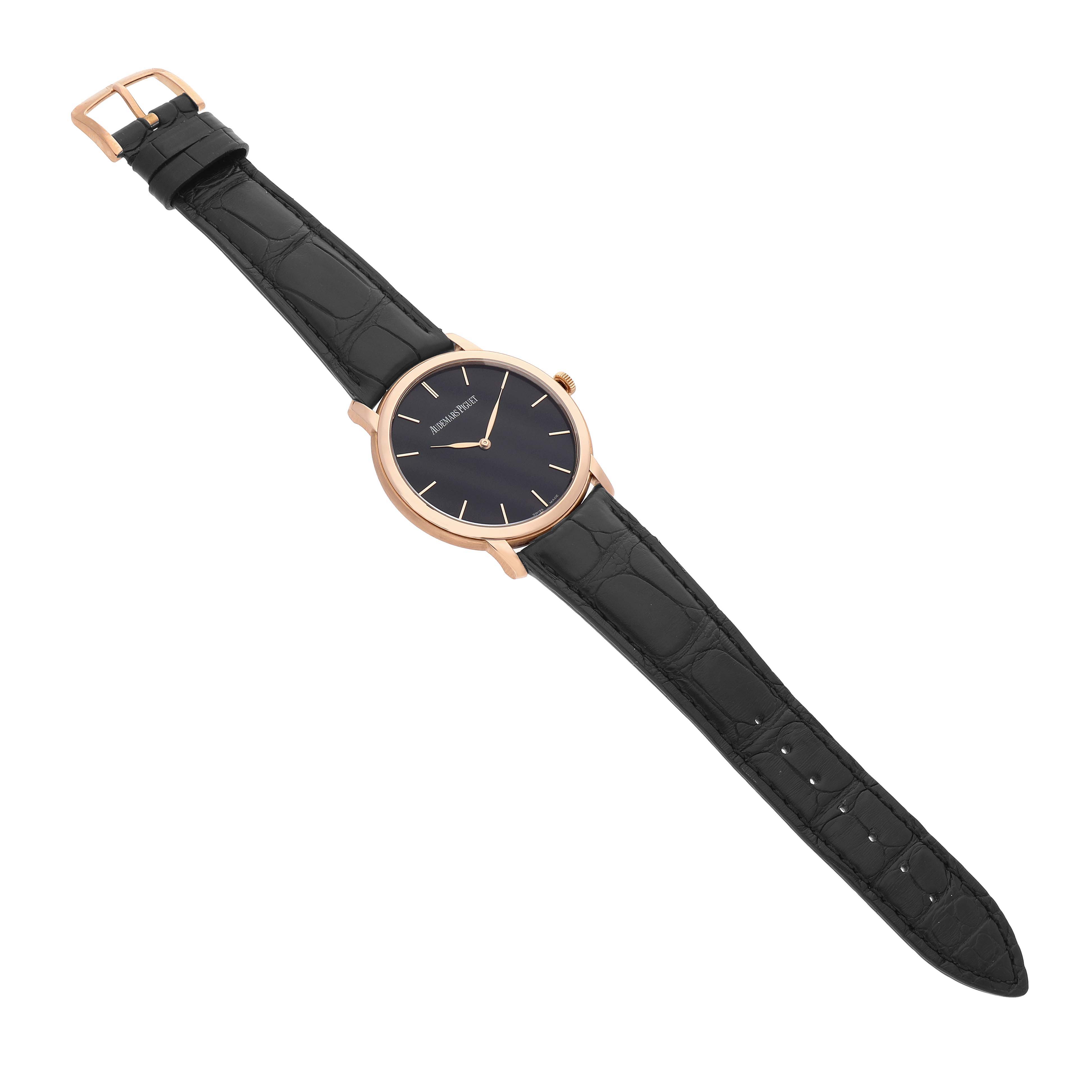 The Audemars Piguet Jules 15180R Men's Rose Gold Black Dial watch is shown from a top-down angle, displaying the face, case, and black leather strap.