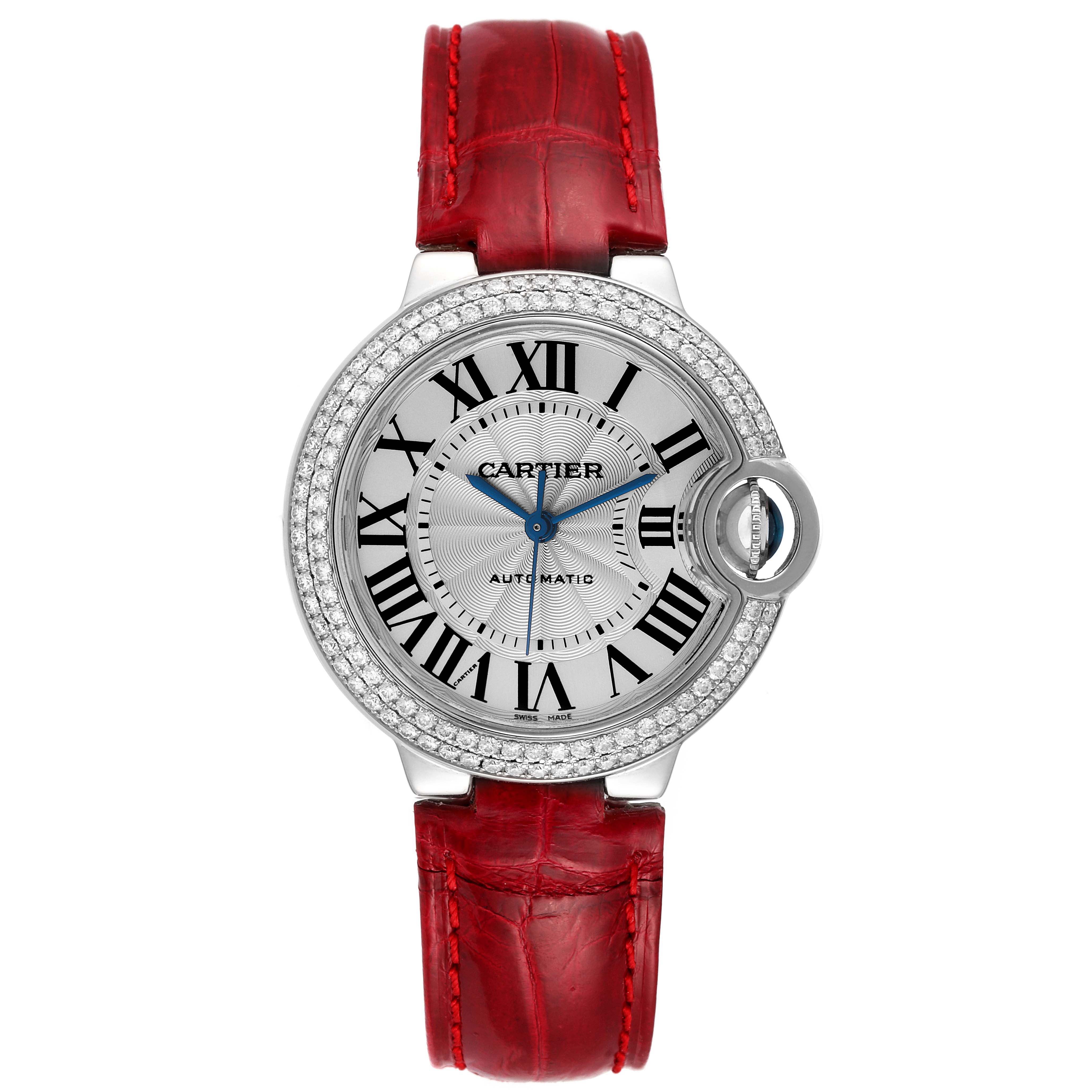 The image shows a Cartier Ballon Bleu WE902067 Women
s White Gold Silver Dial WE902067 Women
s White Gold Silver Dial watch from a front angle, highlighting its red strap, Roman numeral dial, and diamond-encrusted bezel.