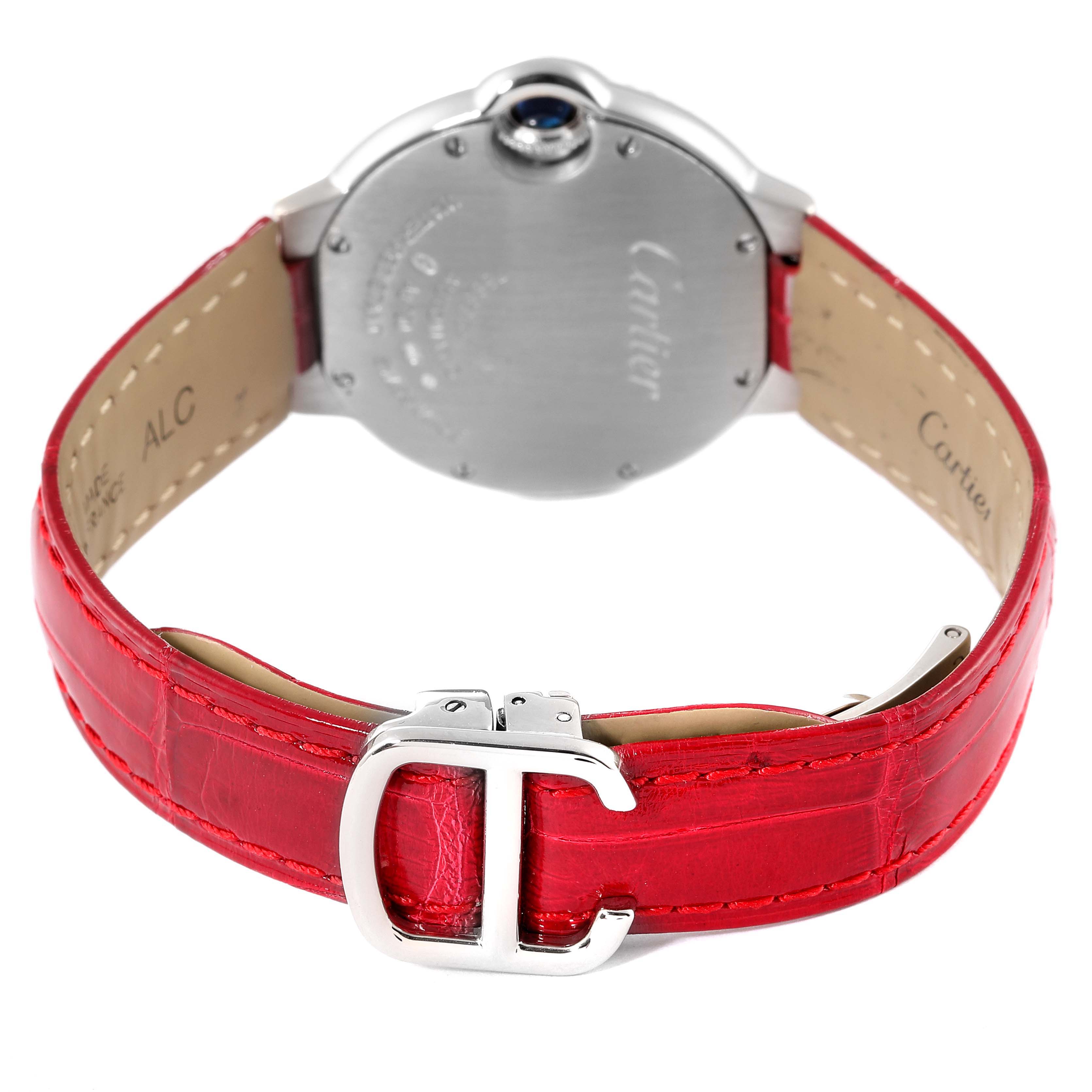 The image shows the back of a Cartier Ballon Bleu WE902067 Women
s White Gold Silver Dial WE902067 Women
s White Gold Silver Dial watch with a red leather strap and a metal buckle.