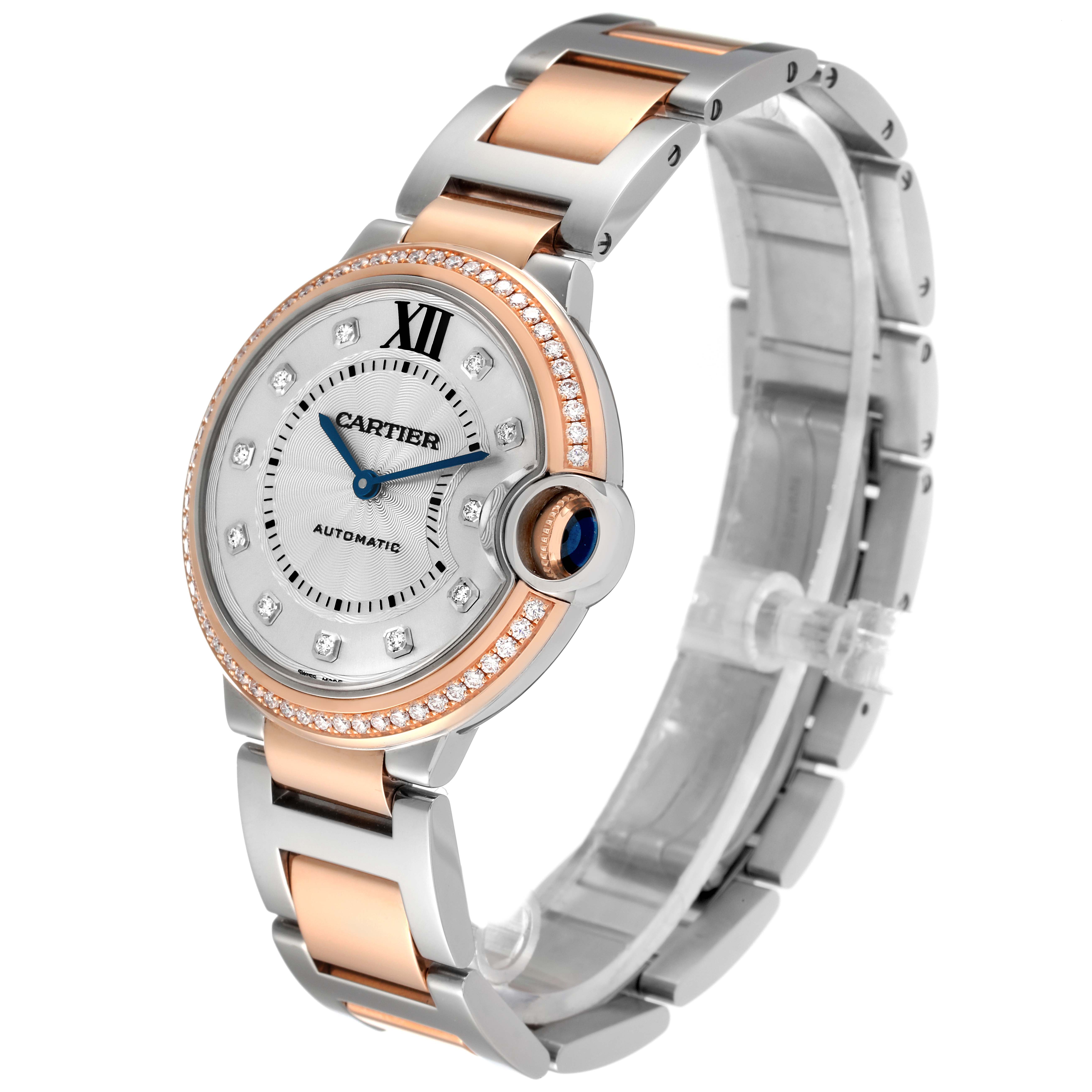 The image displays a side angle of a Cartier Ballon Bleu W3BB0004 Women's Steel and Gold (two tone) Silver Dial W3BB0004 Women's Steel and Gold (two tone) Silver Dial watch, showcasing its round dial, metal strap, and crown with a blue cabochon.