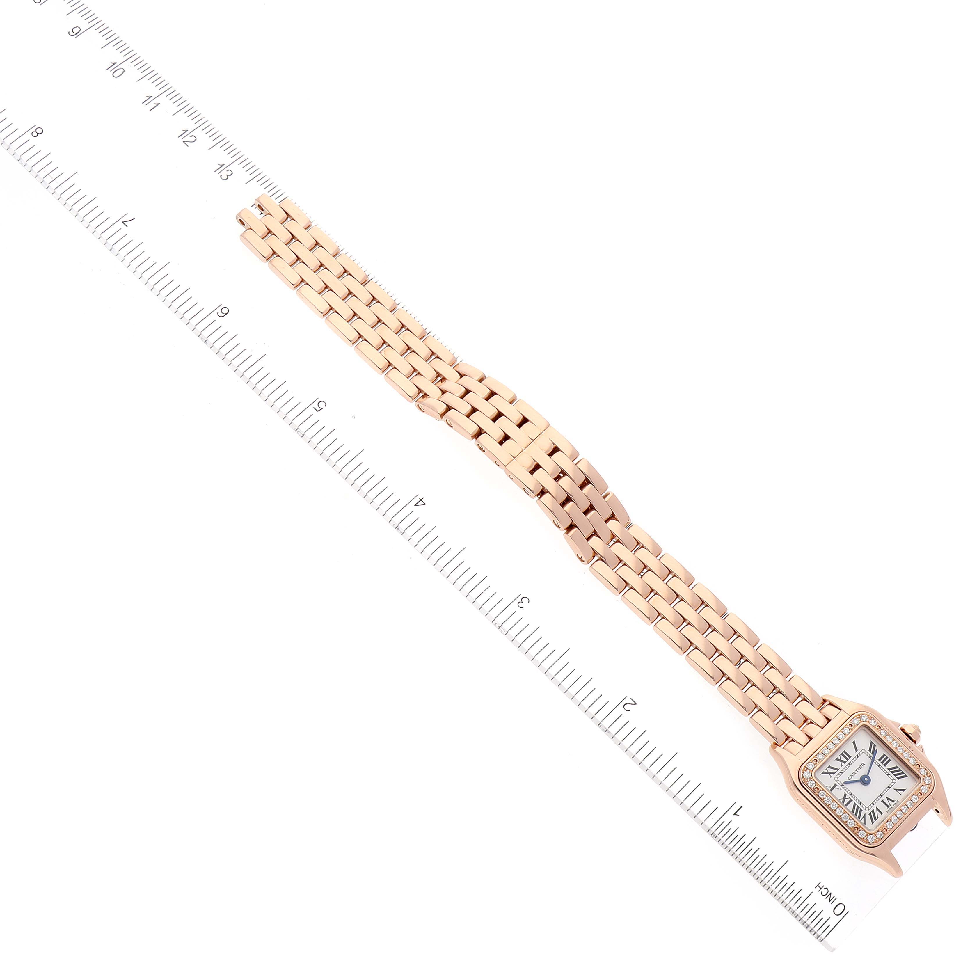 The image shows a Cartier Panthere WJPN0008 Women's Rose Gold Silver Dial WJPN0008 Women's Rose Gold Silver Dial model watch laid flat with a ruler for scale, displaying the watch face and gold link bracelet.