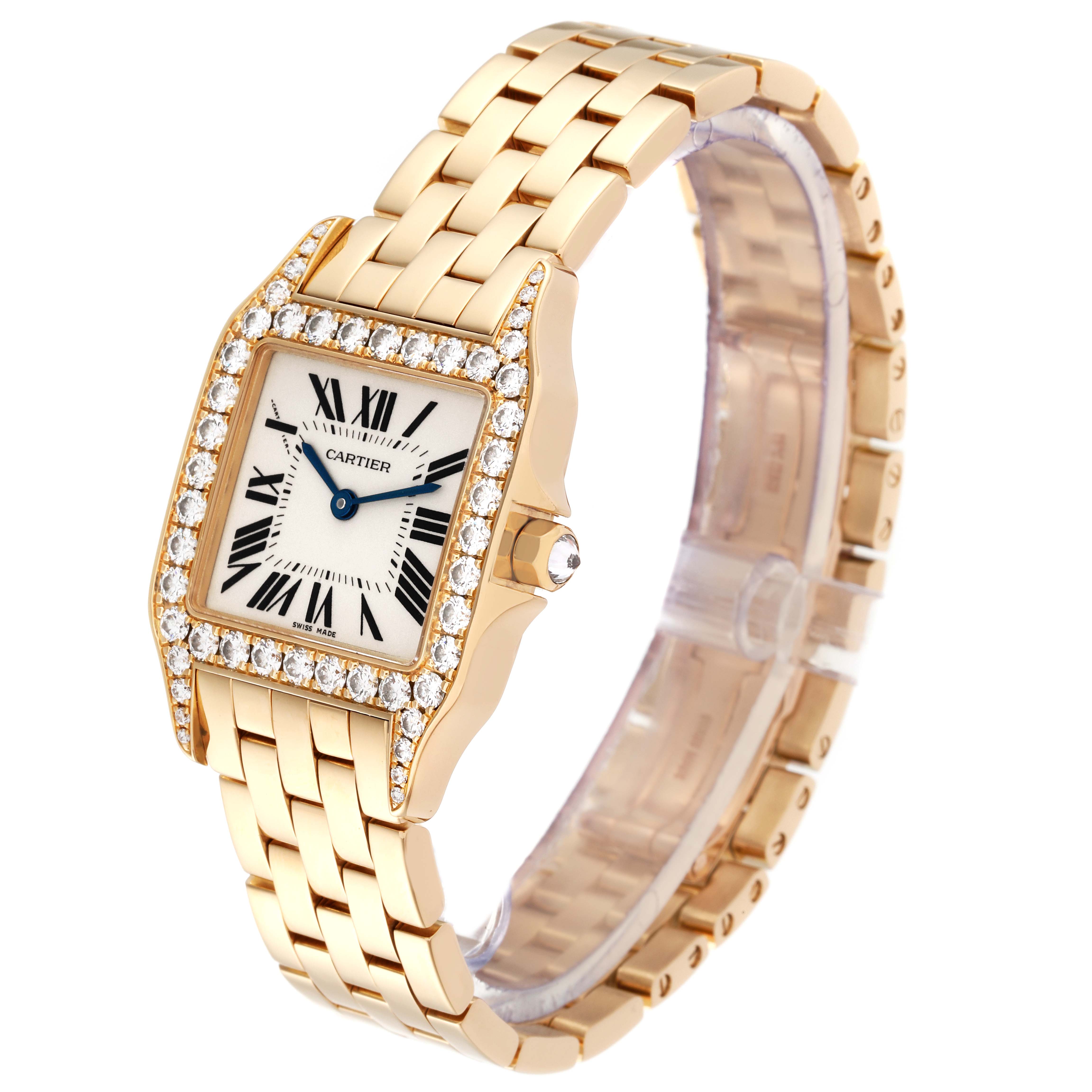 A Cartier Santos Demoiselle WF9002Y7 Women's Yellow Gold Silver Dial WF9002Y7 Women's Yellow Gold Silver Dial watch is shown at an angled view, highlighting the diamond-studded bezel and gold bracelet.