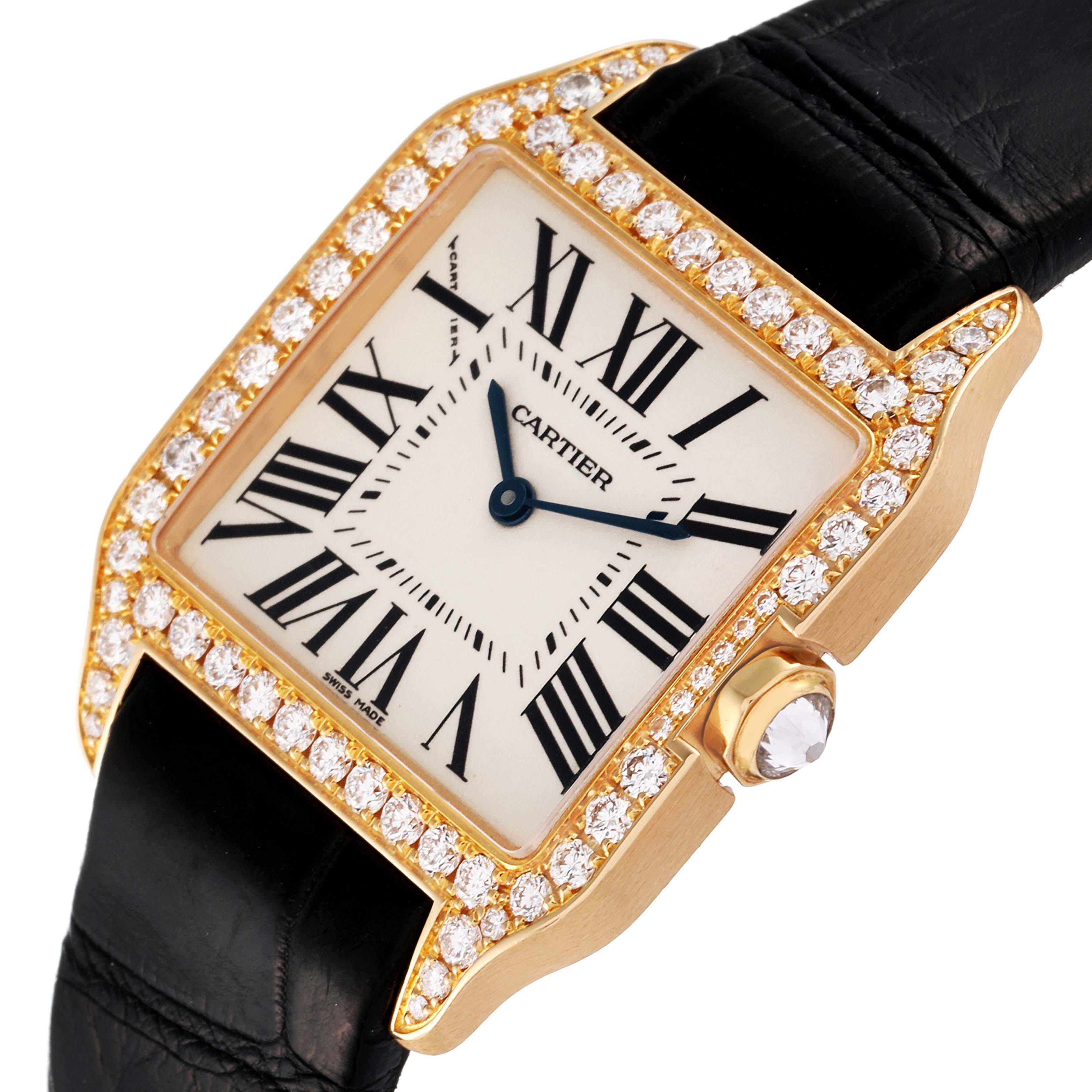 The image shows a close-up of the Cartier Santos Dumont WH100351 Men's Yellow Gold Silver Dial WH100351 Men's Yellow Gold Silver Dial watch face, bezel with diamonds, and part of its black strap at an angled view.