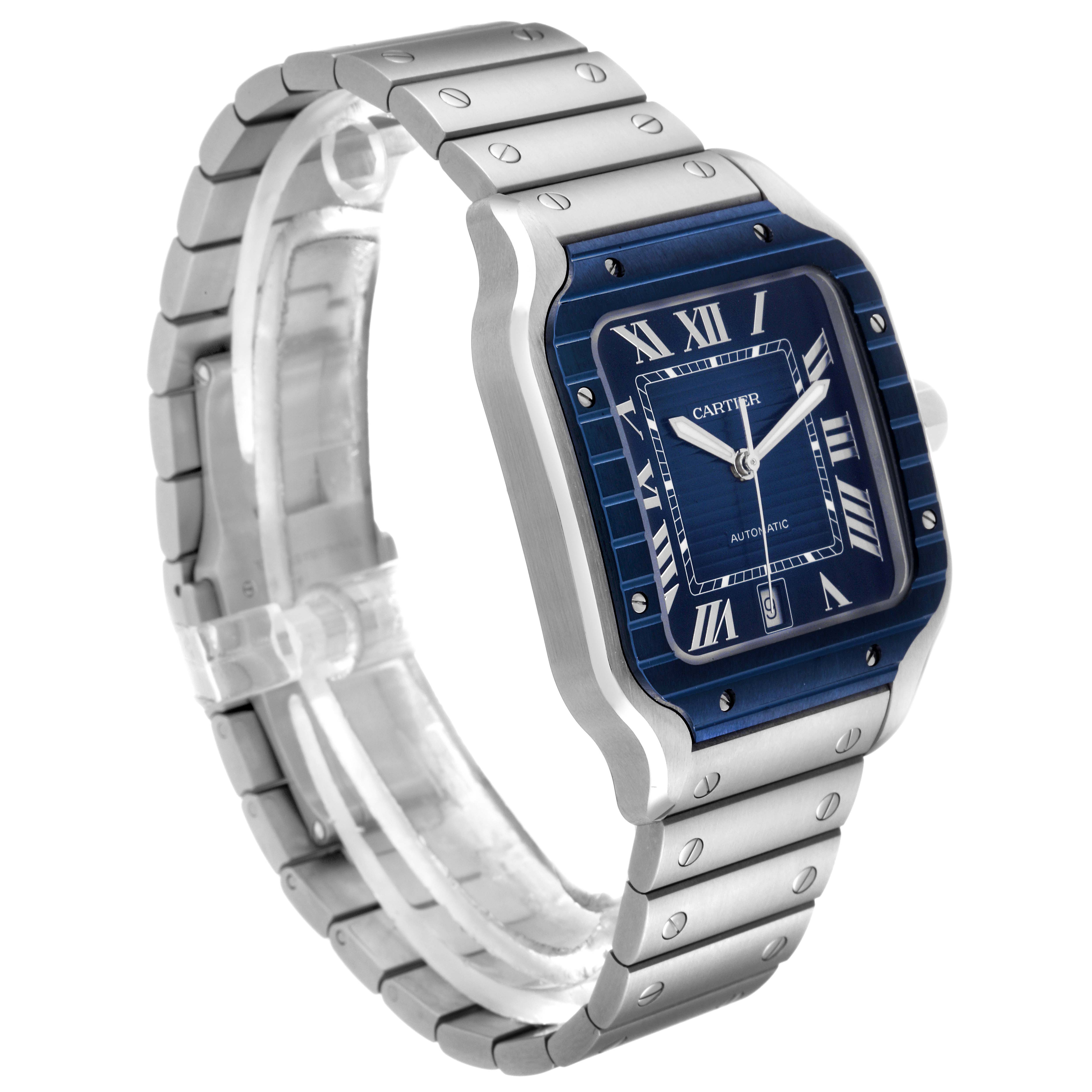 The image shows a side angle of a Santos model watch by Cartier, highlighting its blue dial, Roman numerals, stainless steel case, and bracelet.