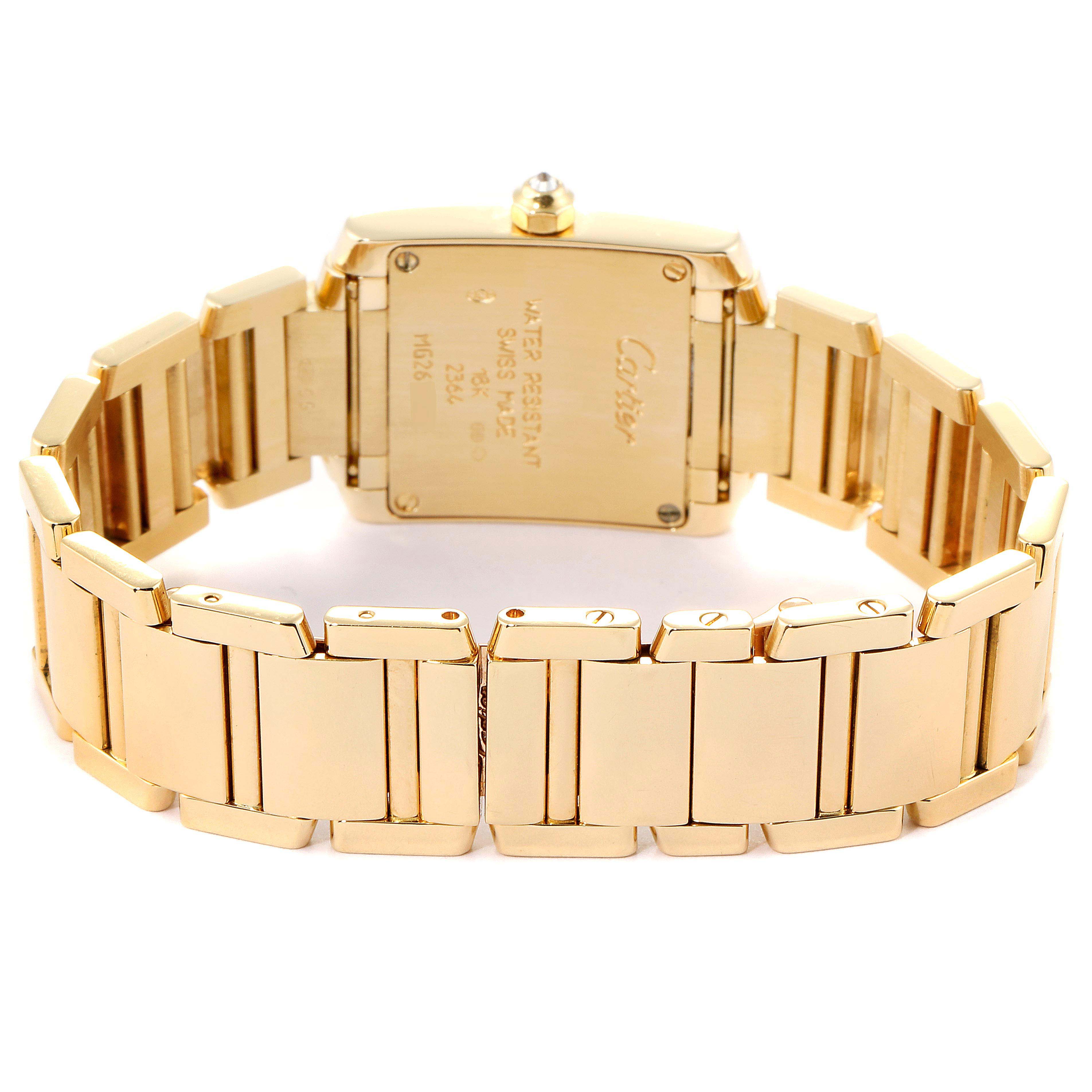 The image shows the back view of a Cartier Tank Française watch, highlighting its gold bracelet and case back.