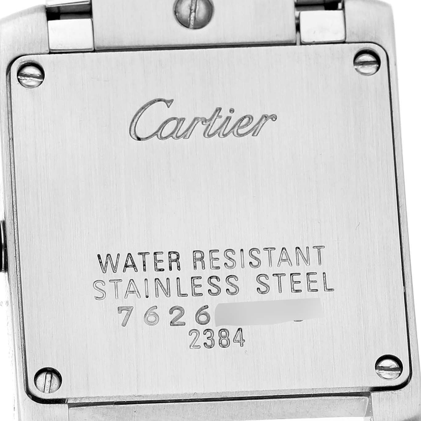 The image shows the back casing of the Cartier Tank Française watch, highlighting engraved details and screws.