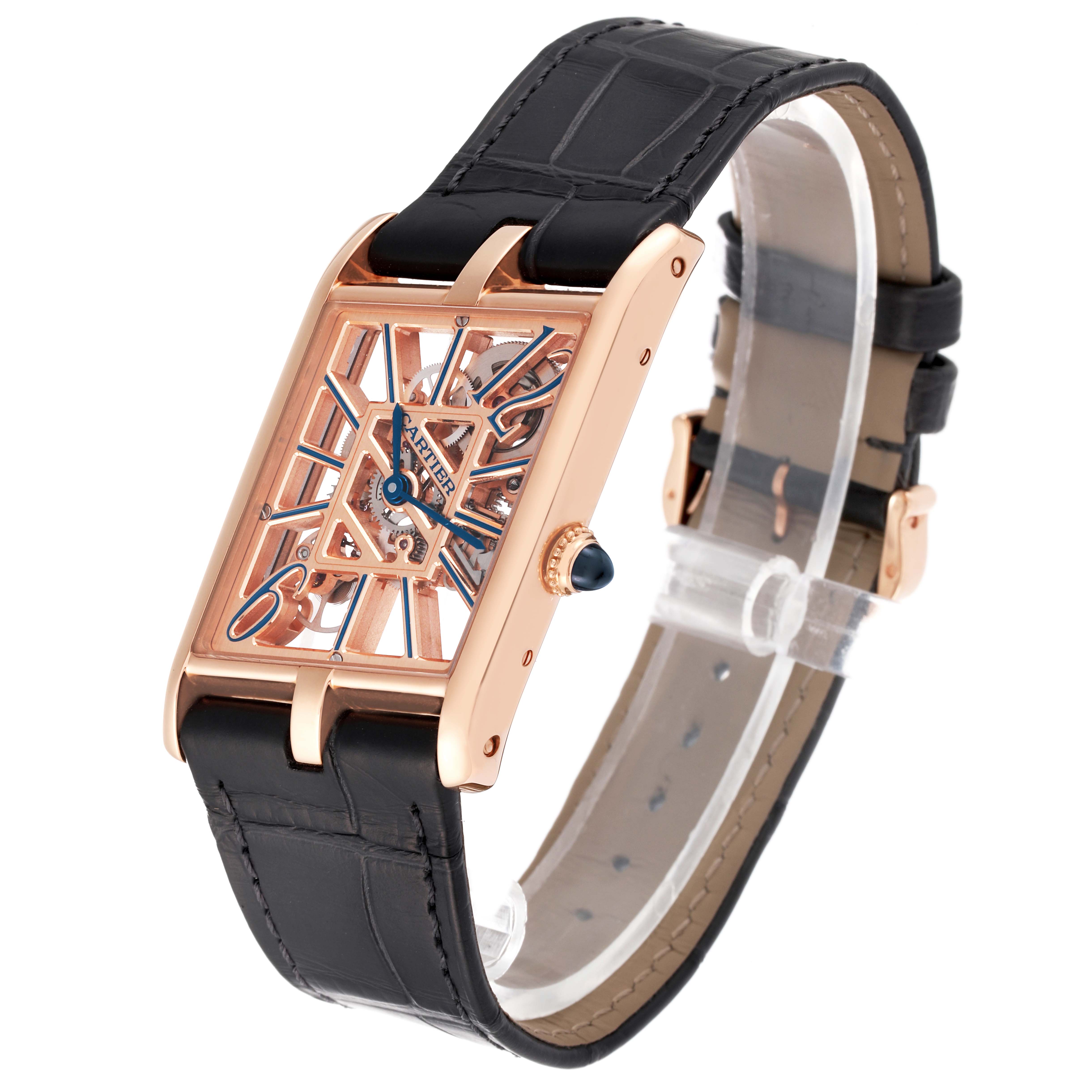 The Tank Asymétrique by Cartier is shown at an angled view, highlighting its rose gold case, black leather strap, skeleton dial, and blue hands.