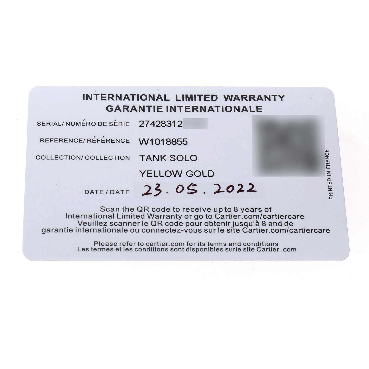 The image shows an International Limited Warranty card for the Cartier Tank Solo W1018855 Men's Yellow Gold Silver Dial watch model.