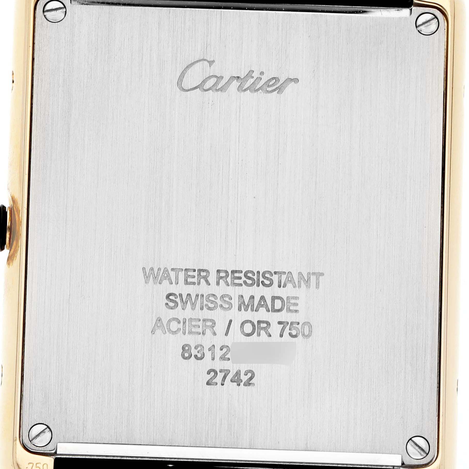 The image shows the back case of a Cartier Tank Solo W1018855 Men's Yellow Gold Silver Dial watch, displaying engravings and screws.
