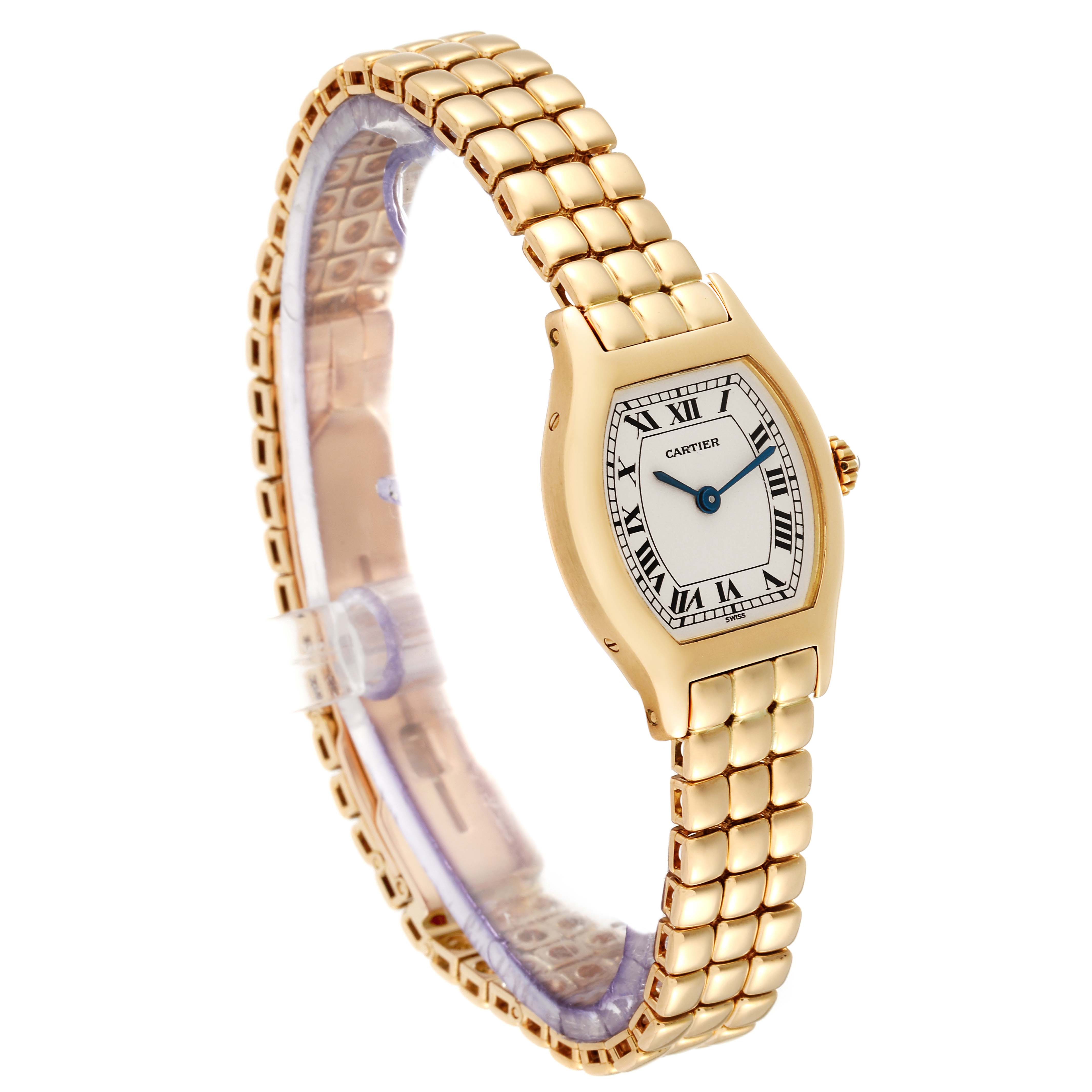 The image shows a side-angle view of a Cartier Tortue Women's Yellow Gold Silver Dial Women's Yellow Gold Silver Dial watch, highlighting its gold bracelet and case.