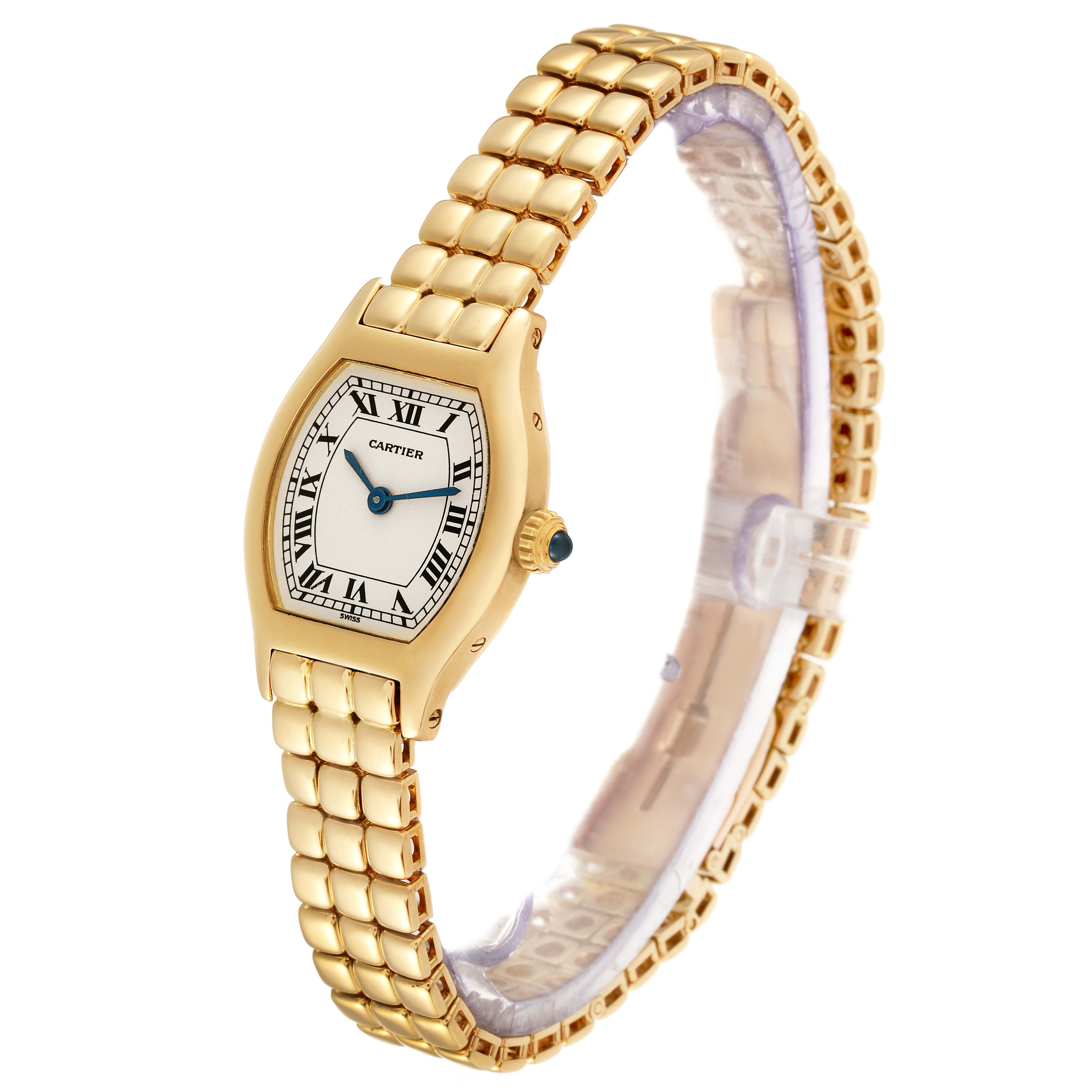 The image shows a Cartier Tortue Women's Yellow Gold Silver Dial Women's Yellow Gold Silver Dial watch from a slightly angled side view, highlighting the gold bracelet and face with Roman numerals.