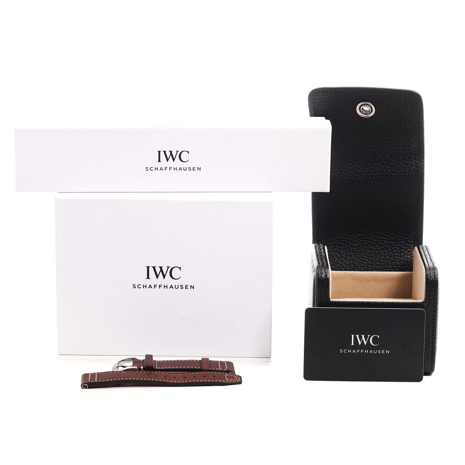 The image shows IWC Pilot IW328207 Men's Stainless Steel Silver Dial watch accessories including a leather strap, a presentation box, and packaging from a front angle.