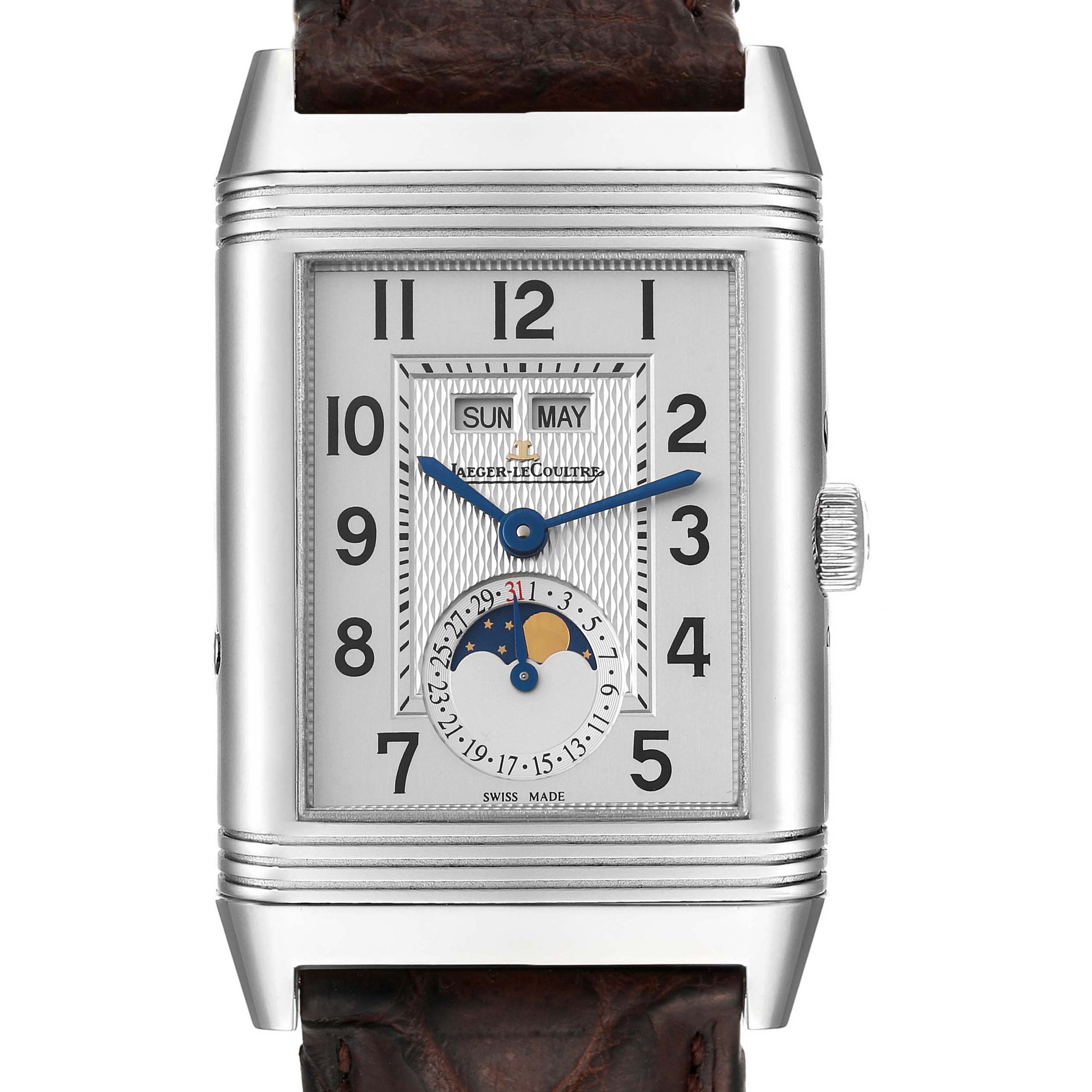 The image shows a frontal view of the Jaeger-LeCoultre Reverso watch, highlighting its dial, hands, day, date, and moon phase indicators.