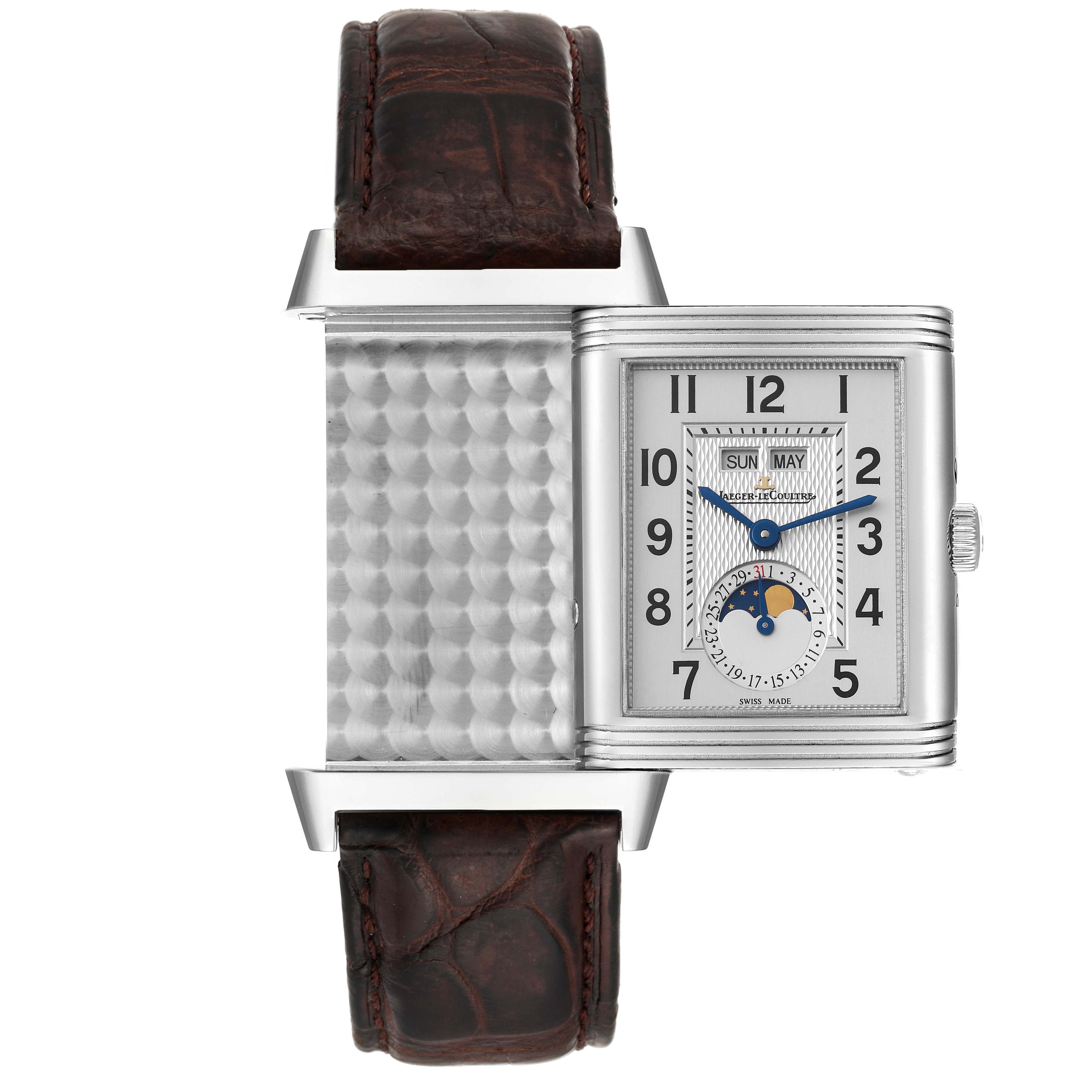 The Jaeger-LeCoultre Reverso watch is shown partially rotated, revealing both the dial and the patterned reverse side.