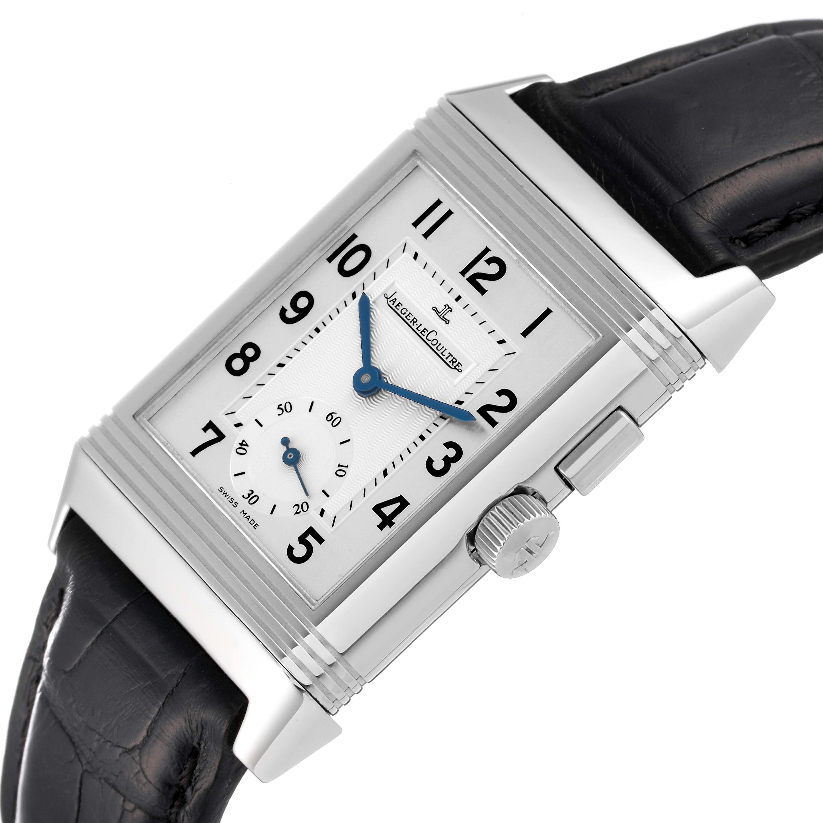 The Jaeger-LeCoultre Reverso watch is shown at an oblique angle, highlighting the face, crown, and leather strap.