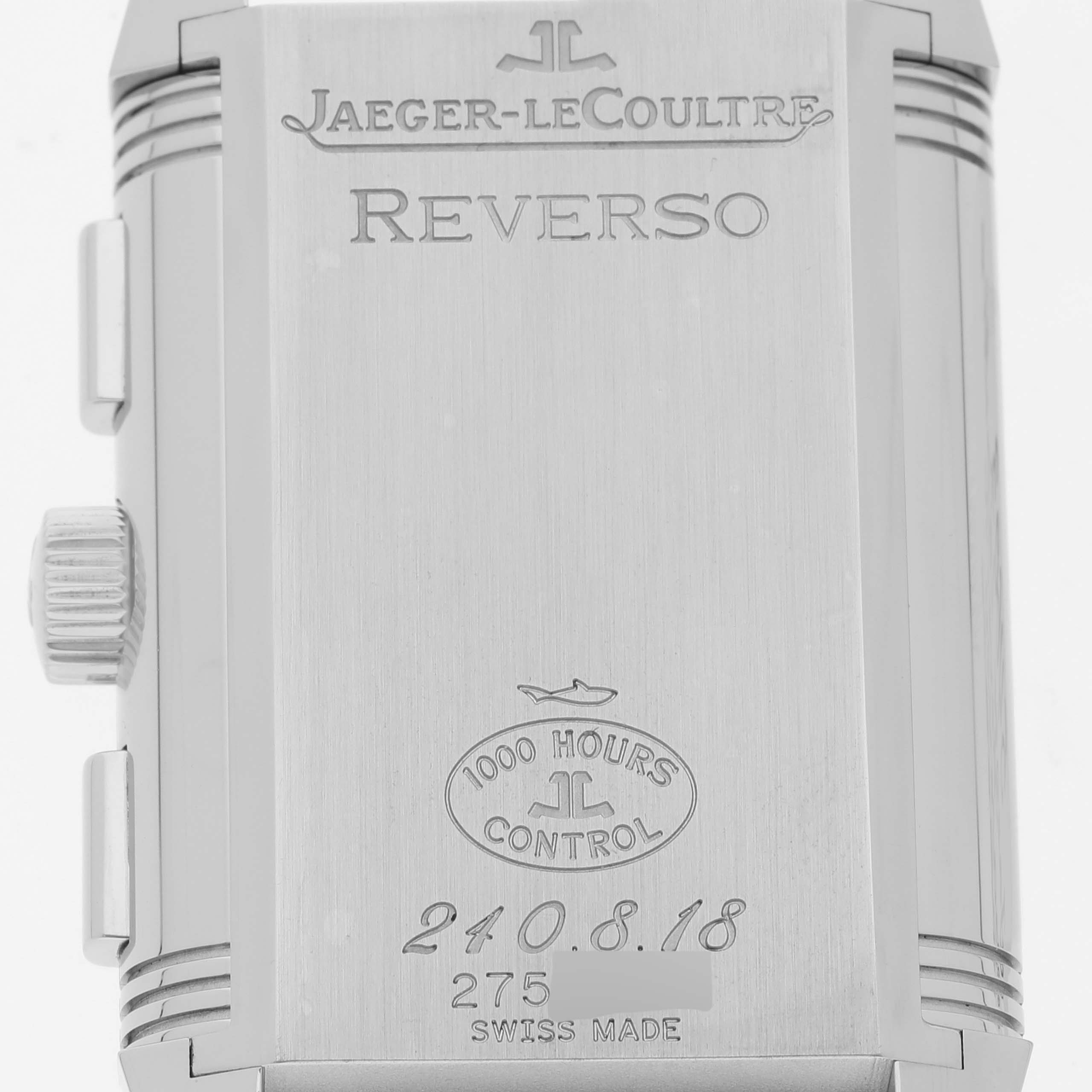 The image shows the back case of a Jaeger-LeCoultre Reverso watch, displaying its engravings and control marks.