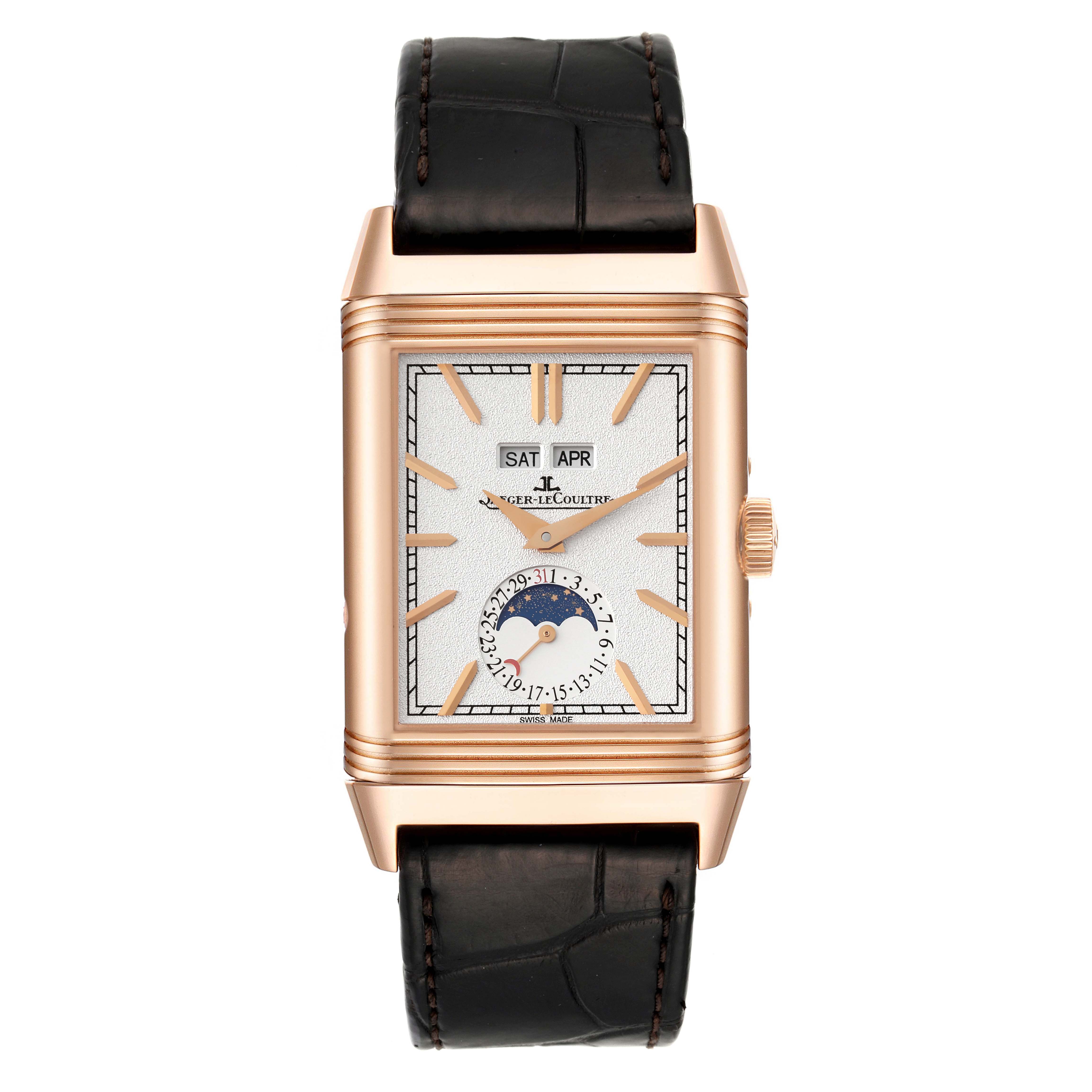 The image shows a front view of the Jaeger-LeCoultre Reverso watch, displaying its face, hour markers, date, moon phase, and leather strap.
