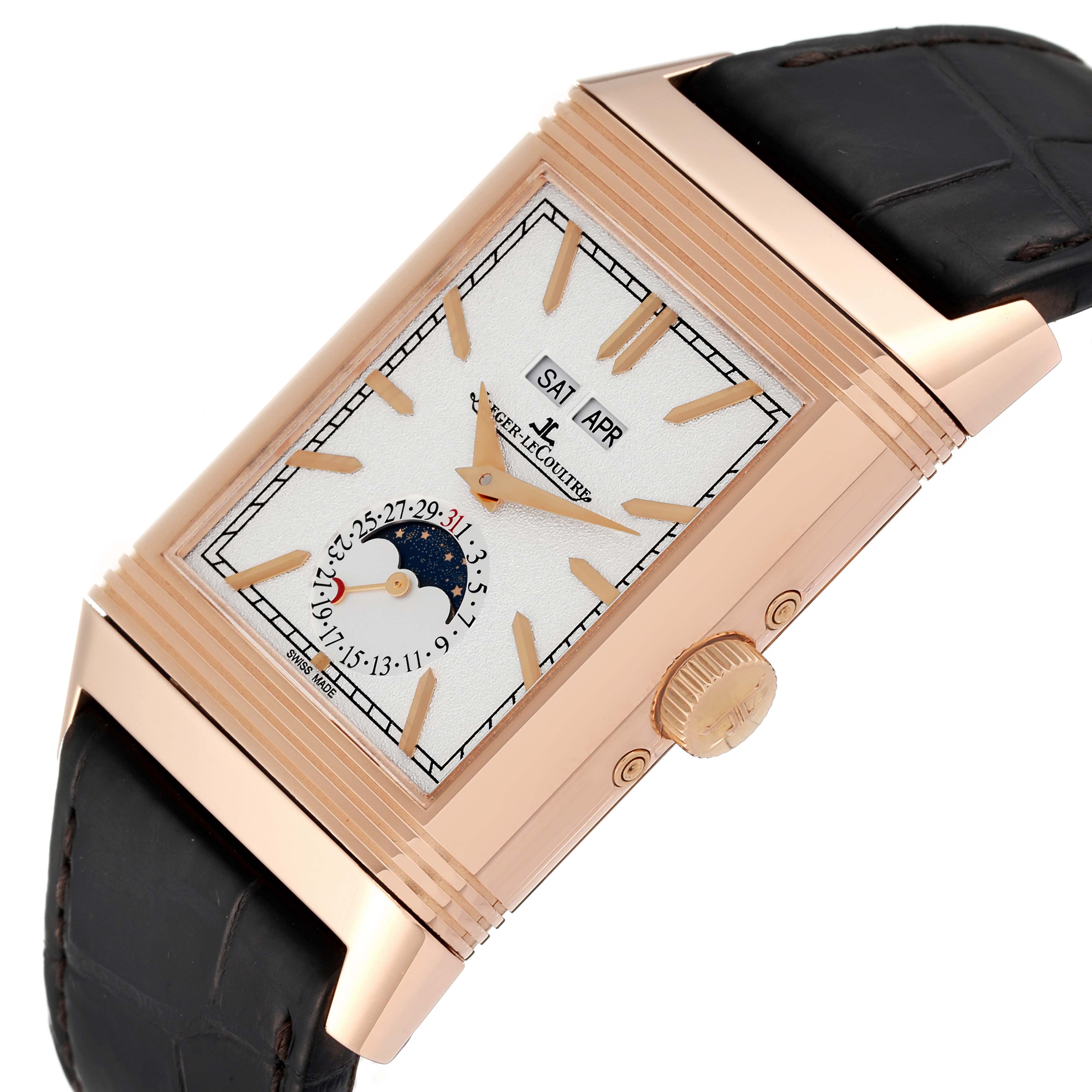 The image shows a side angle of a Jaeger-LeCoultre Reverso watch highlighting its gold case, dial, crown, and leather strap.