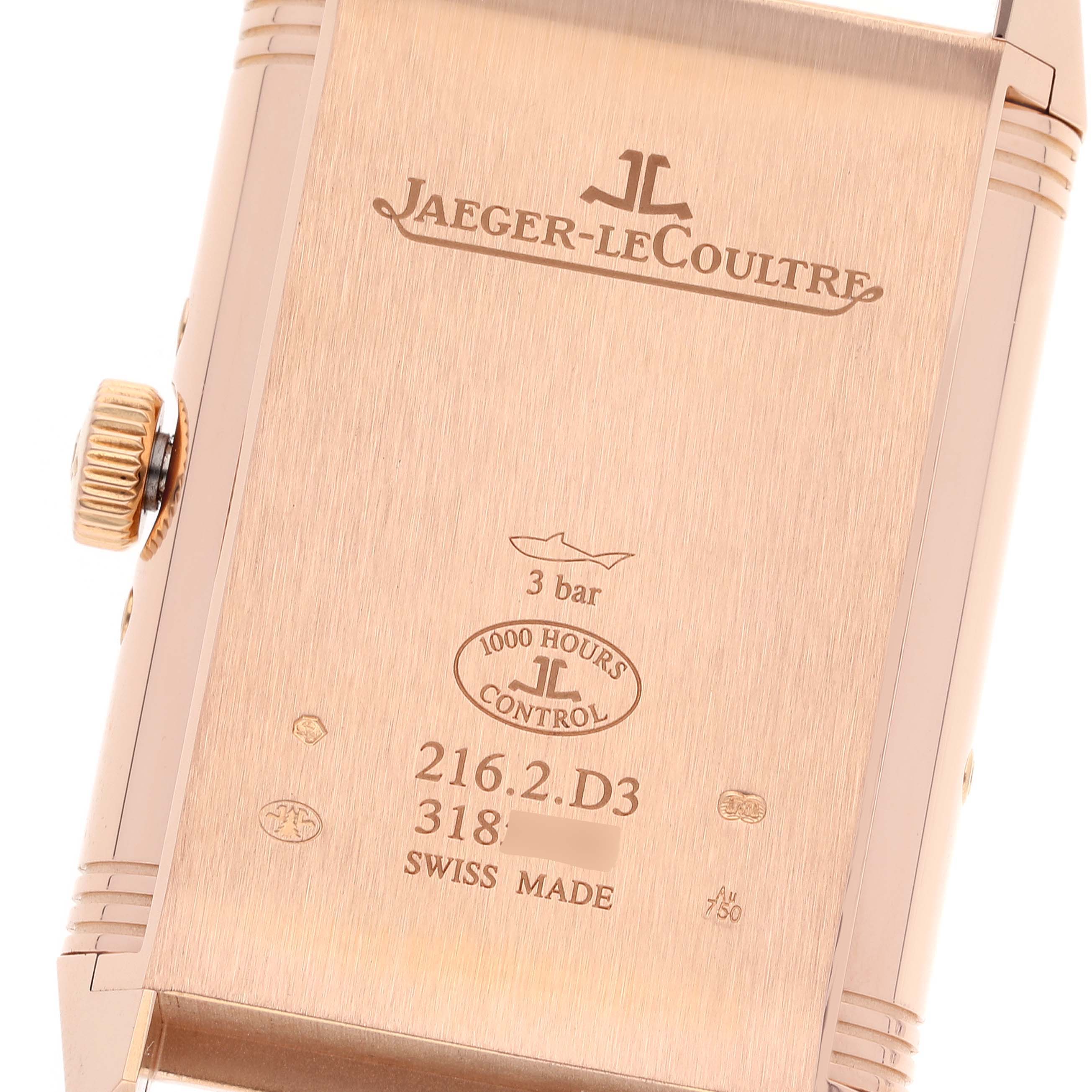 This image shows the case back of a Jaeger-LeCoultre Reverso watch, including the crown and engravings.