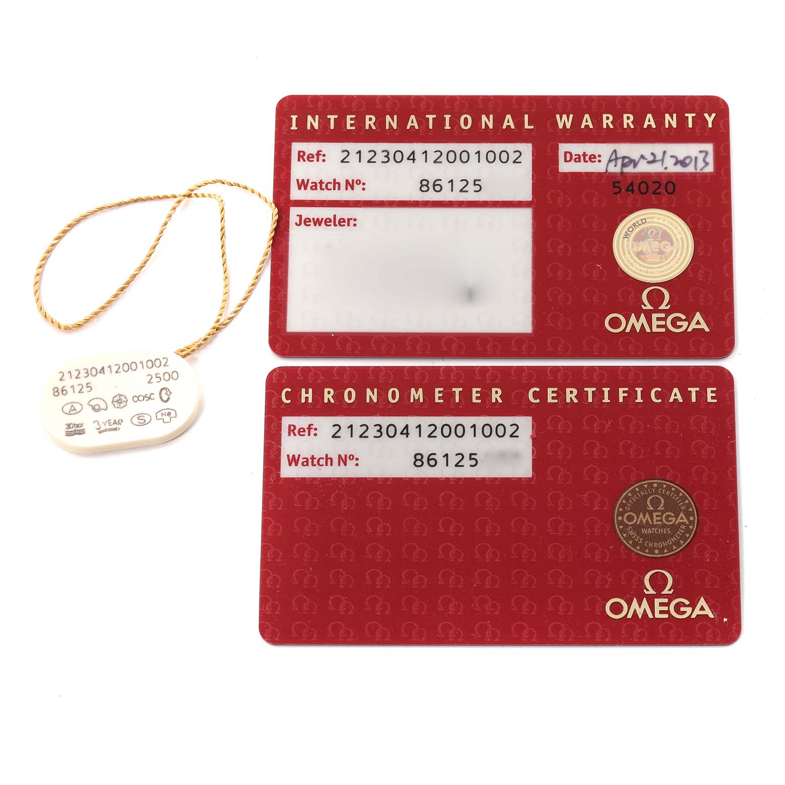 The image shows two red Omega cards (International Warranty and Chronometer Certificate) for a Seamaster model and a tag with a string.